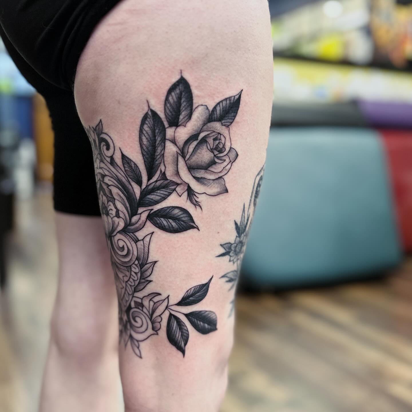 Rose black and grey tattoo on the thigh by Patricia Cunningham