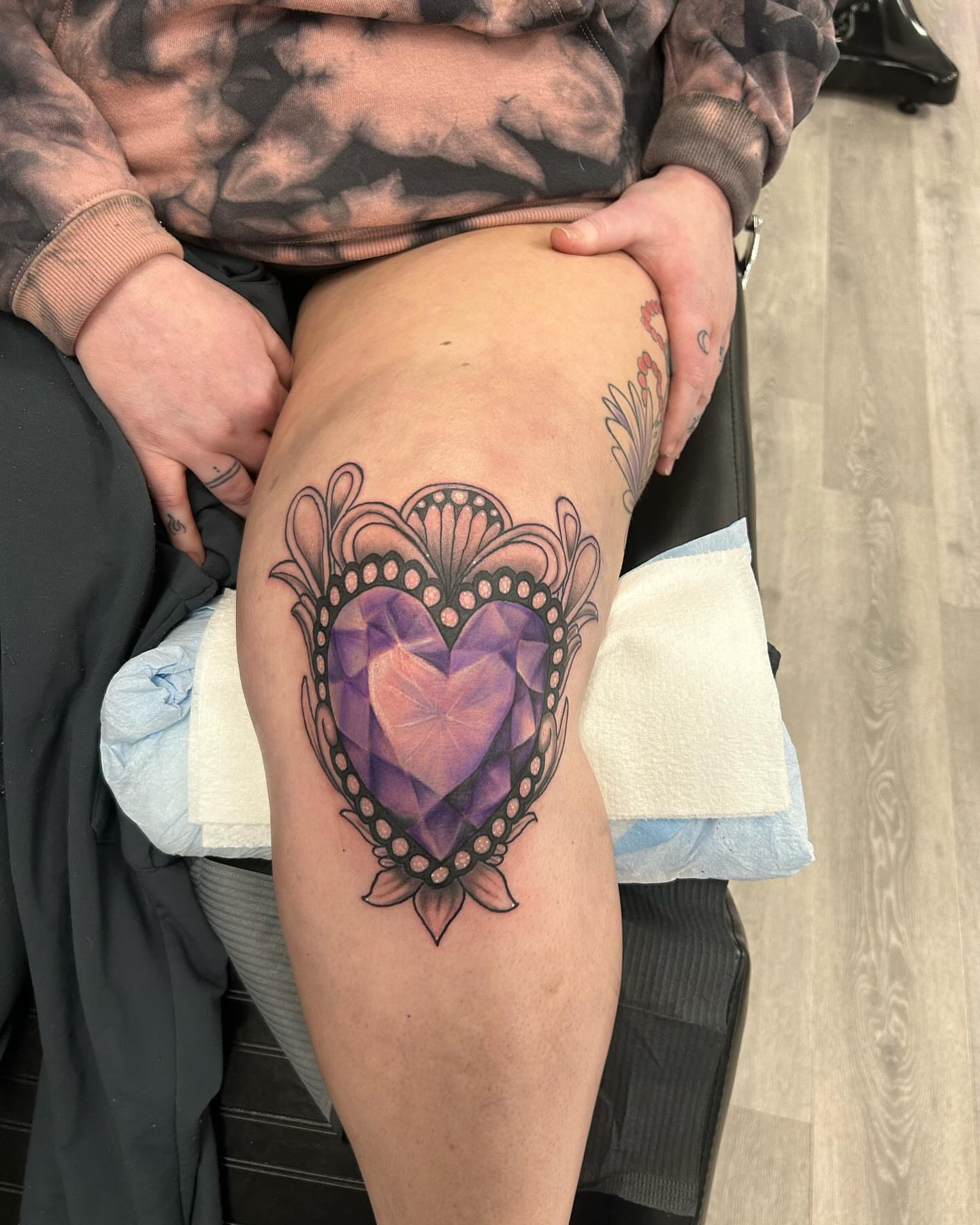 Geometric heart geometric tattoo on the thigh by Alyssa Turner