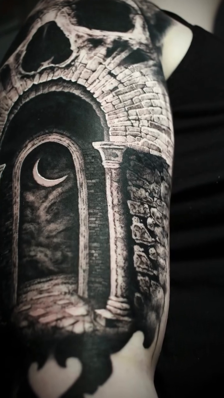 Skull with arched doorway dark realism tattoo by Hollow Priest