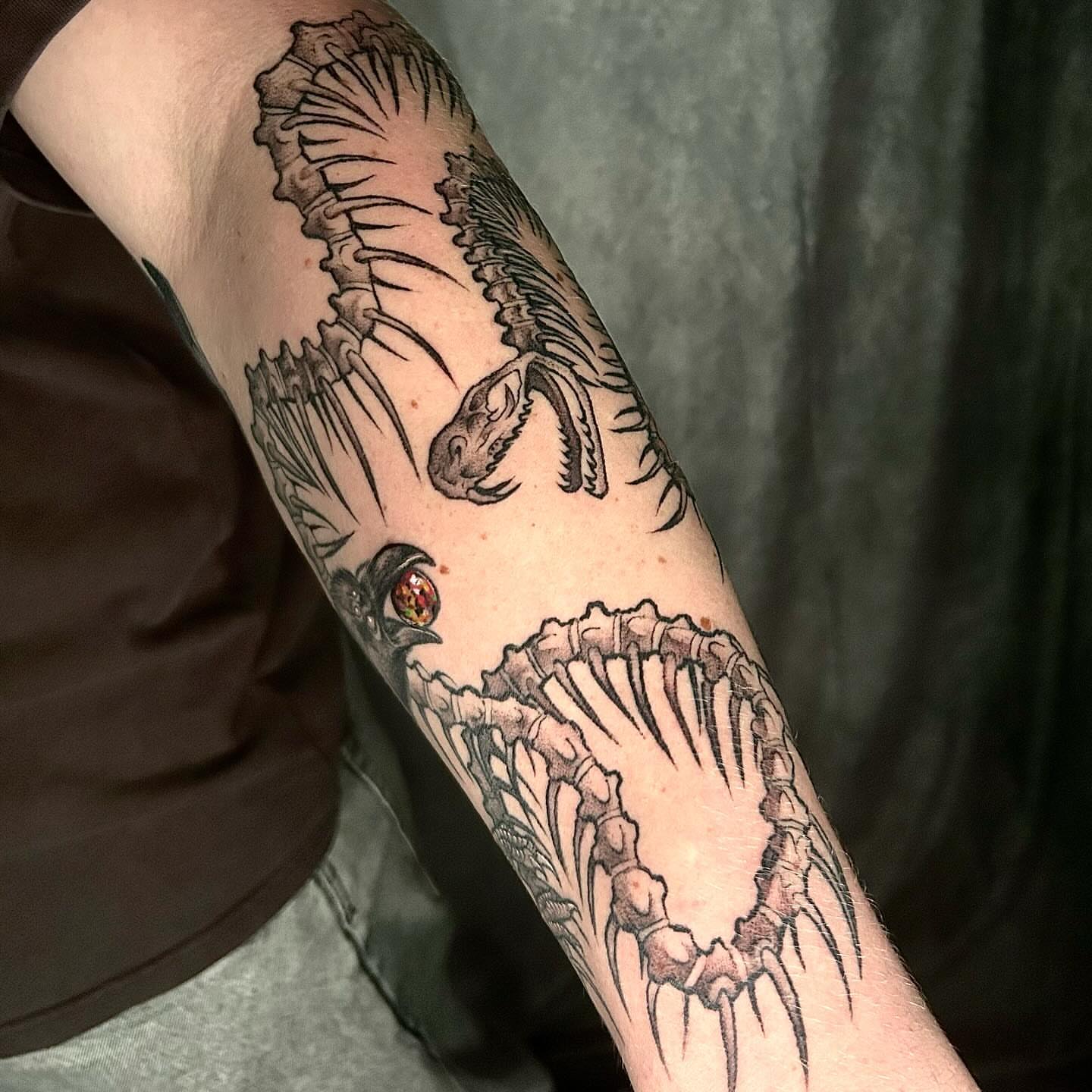 Dinosaur skeleton black and grey tattoo on the forearm by ♡︎ Kaylie ♡︎, Tacoma, Washington