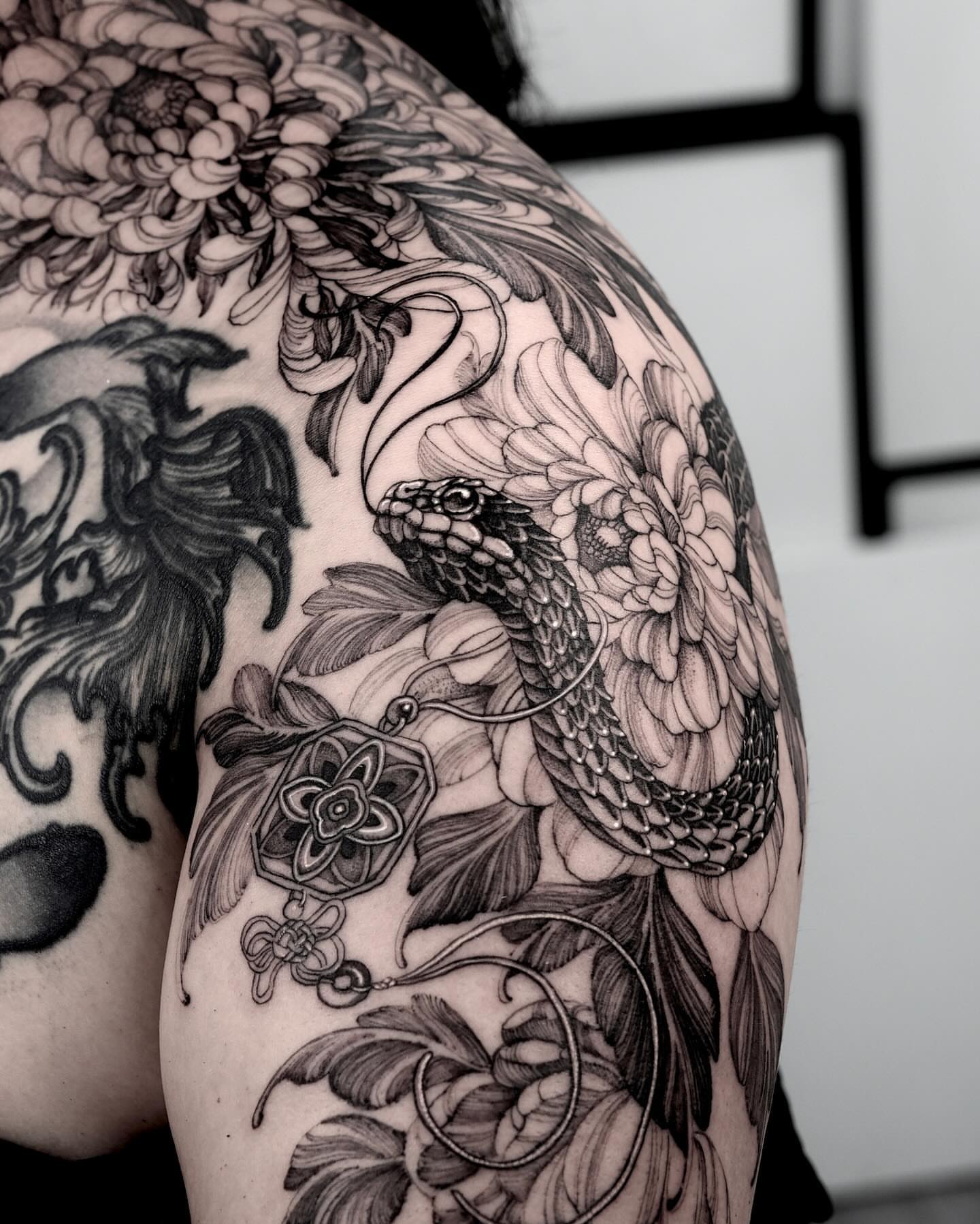 Snake and peony realism tattoo on the shoulder by Yongjun