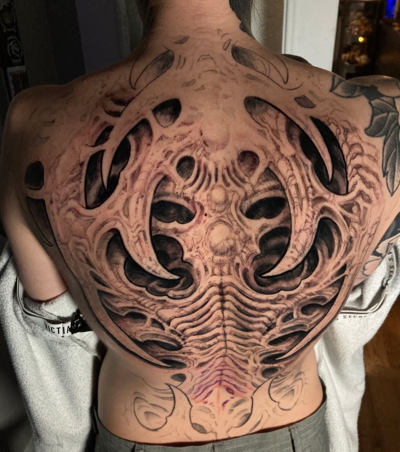 Biomechanical structure geometric tattoo on the back by Jason Wheelwright