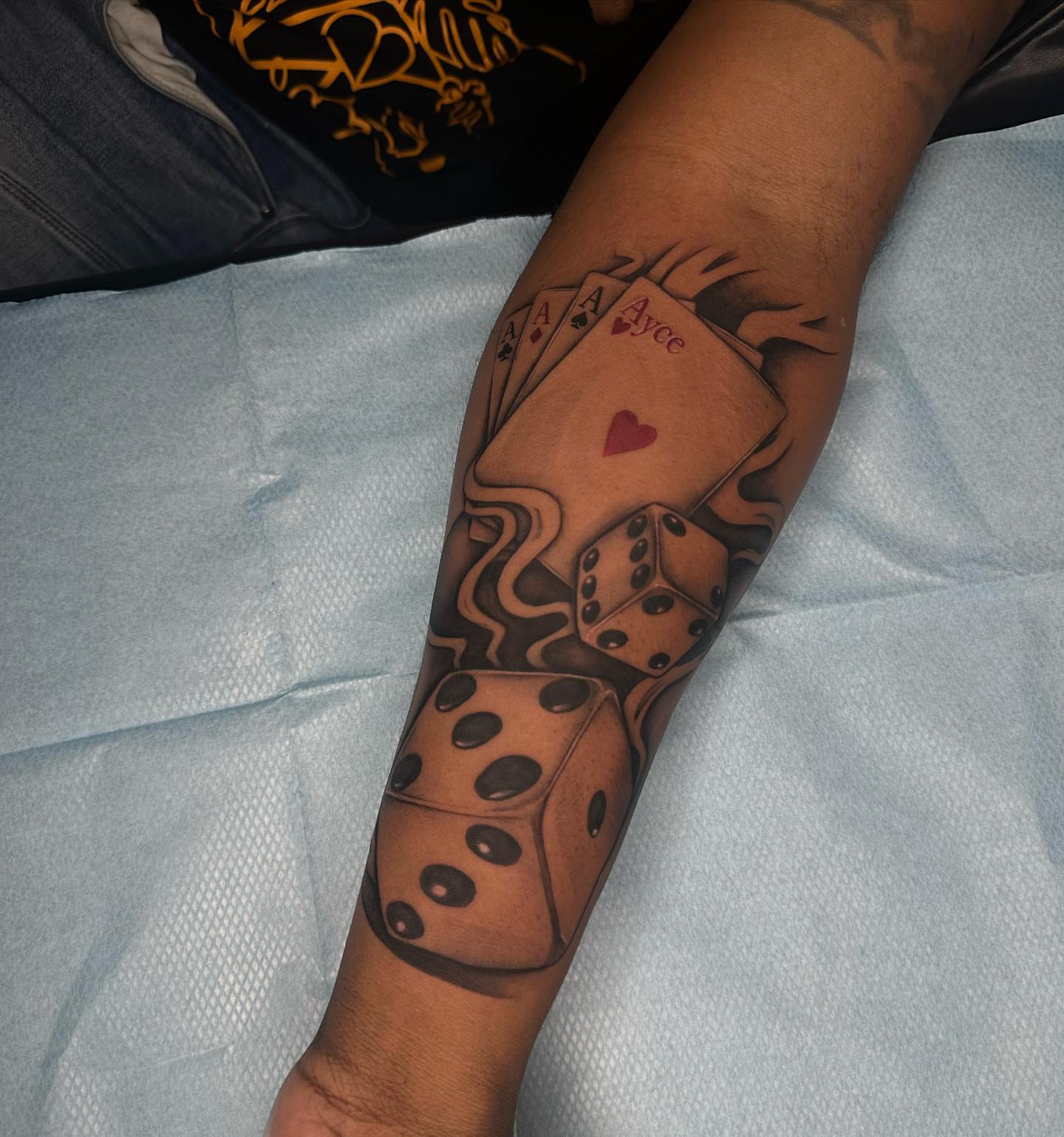 Playing cards and dice black and grey tattoo on the forearm by TattooCrazy🎭