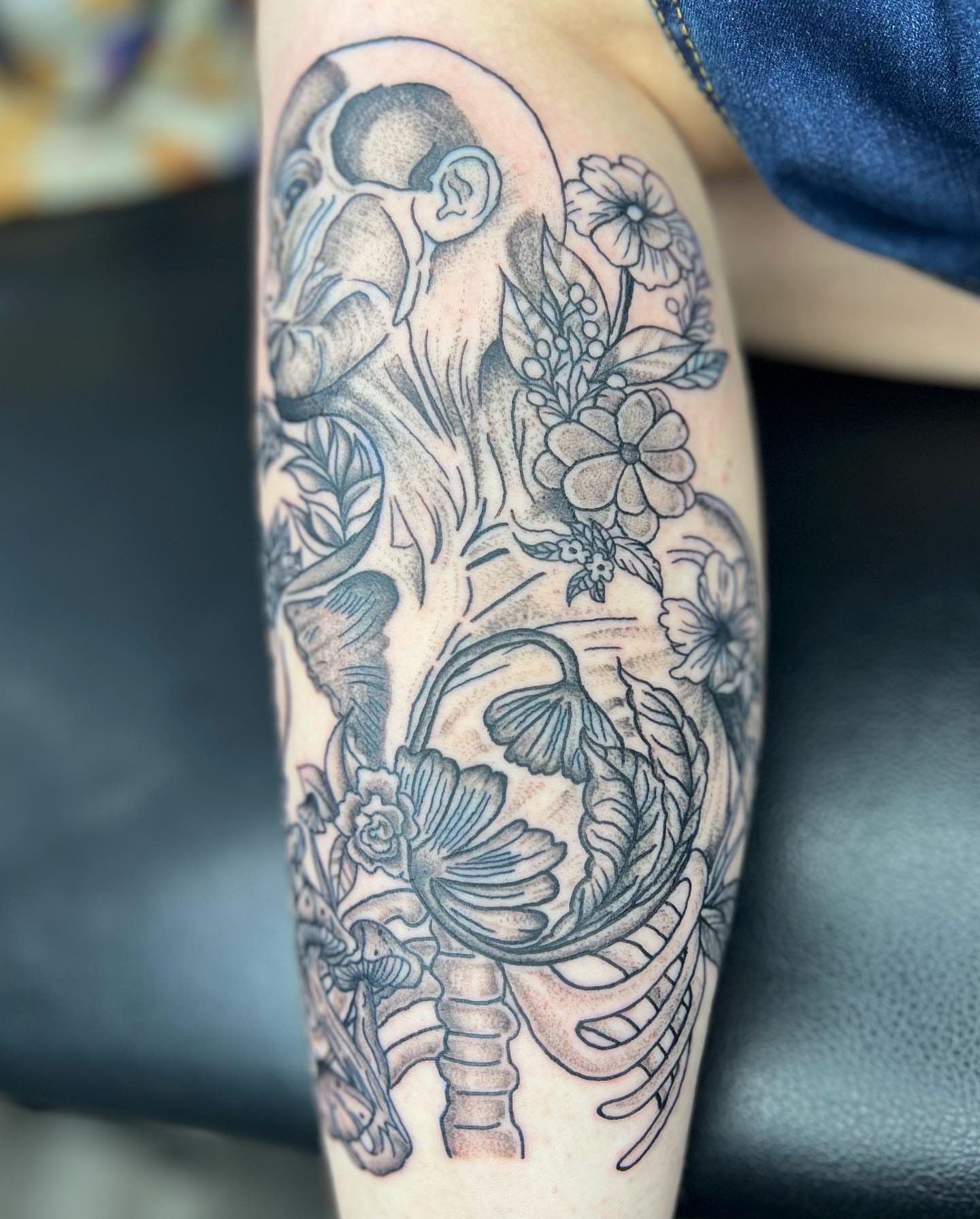 Astronaut and floral black and grey tattoo on the forearm by ✨BADJASS the tattoo artist✨