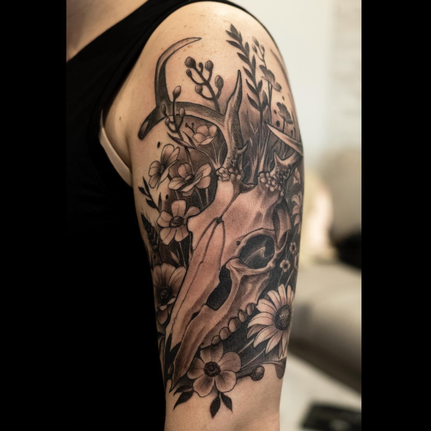 Deer skull with flowers realism tattoo on the forearm by Marvin Silva