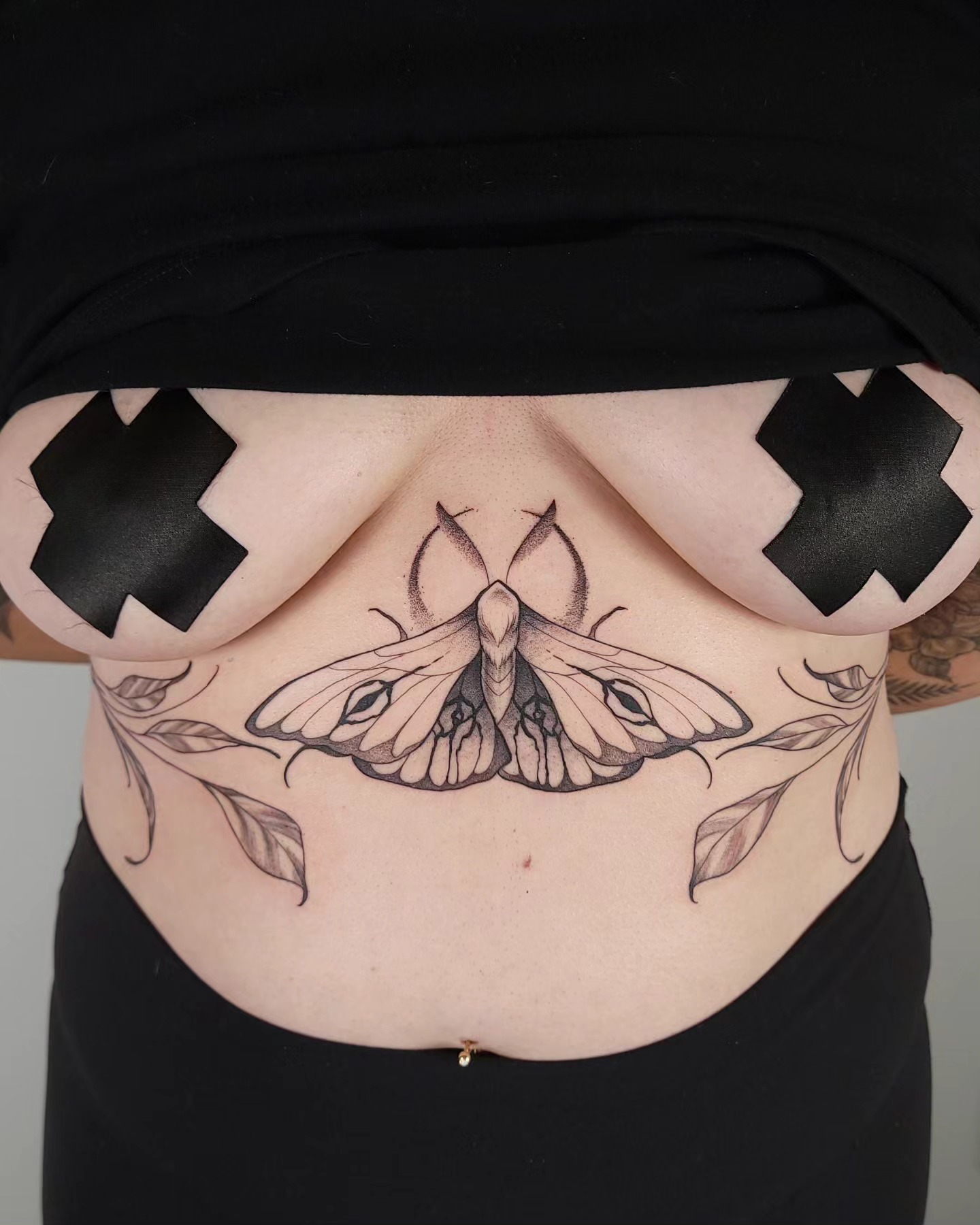 Moth and leaves realism tattoo on the torso by Ghost