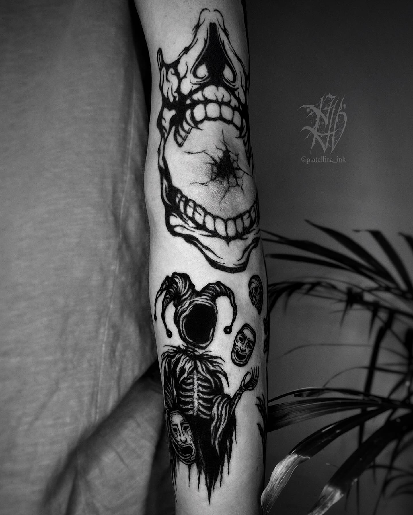 Skull and joker dark realism tattoo on the forearm by Dark Gothic Tattoo