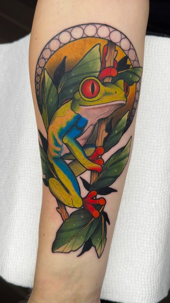 Red-eyed tree frog on a branch realism tattoo by Luis Torres, Harrison, New Jersey