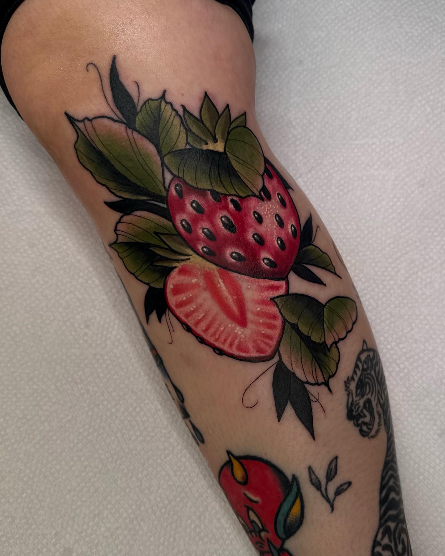Strawberry American traditional tattoo on the forearm by E
