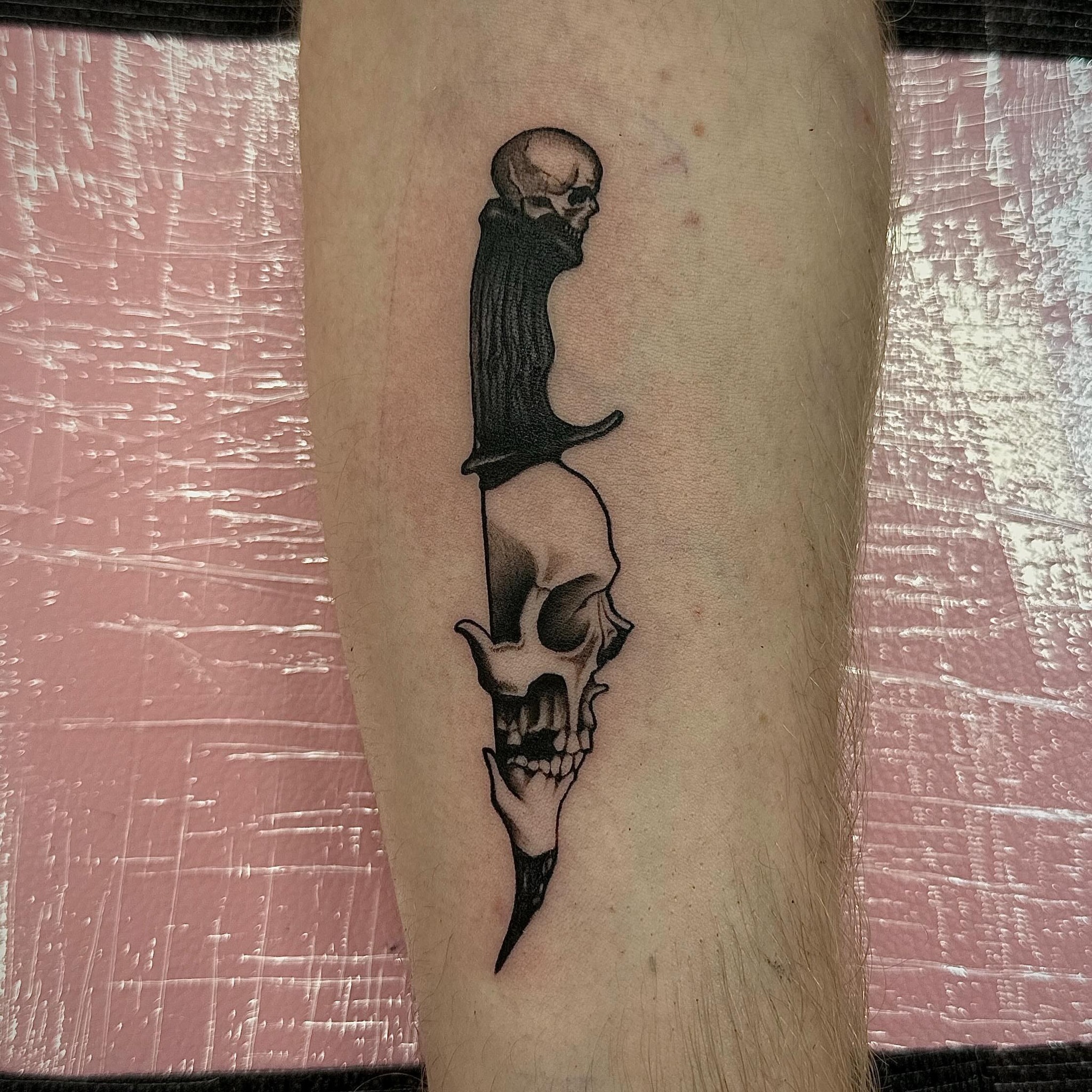 Knife with skull black and grey tattoo on the forearm by Emily‹𝟹