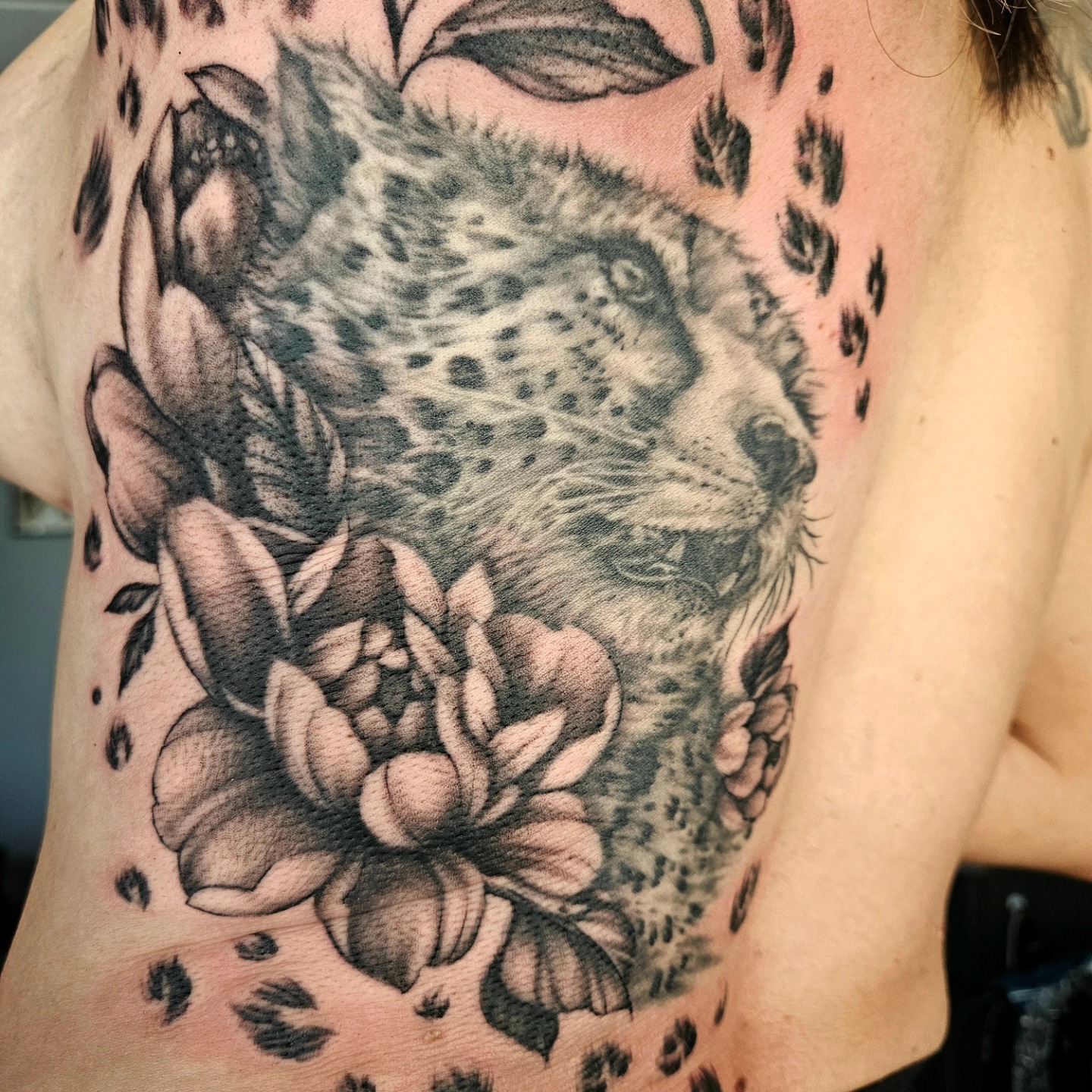 Leopard and flowers realism tattoo on the chest by Chicagoland Tattoo artist - Dany Rojas