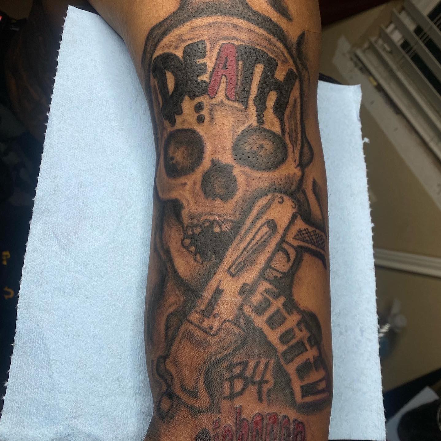 Skull and gun black and grey tattoo on the forearm by dallas tattoo artist, Duncanville, Texas