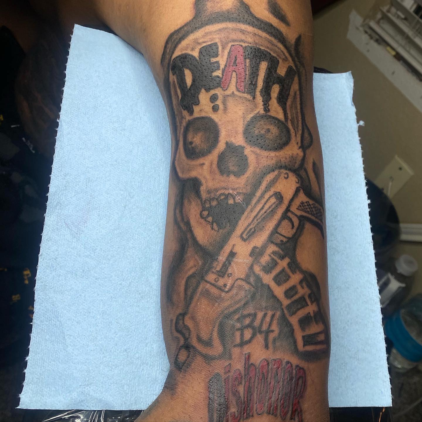 Skull with gun American traditional tattoo on the forearm by dallas tattoo artist, Duncanville, Texas