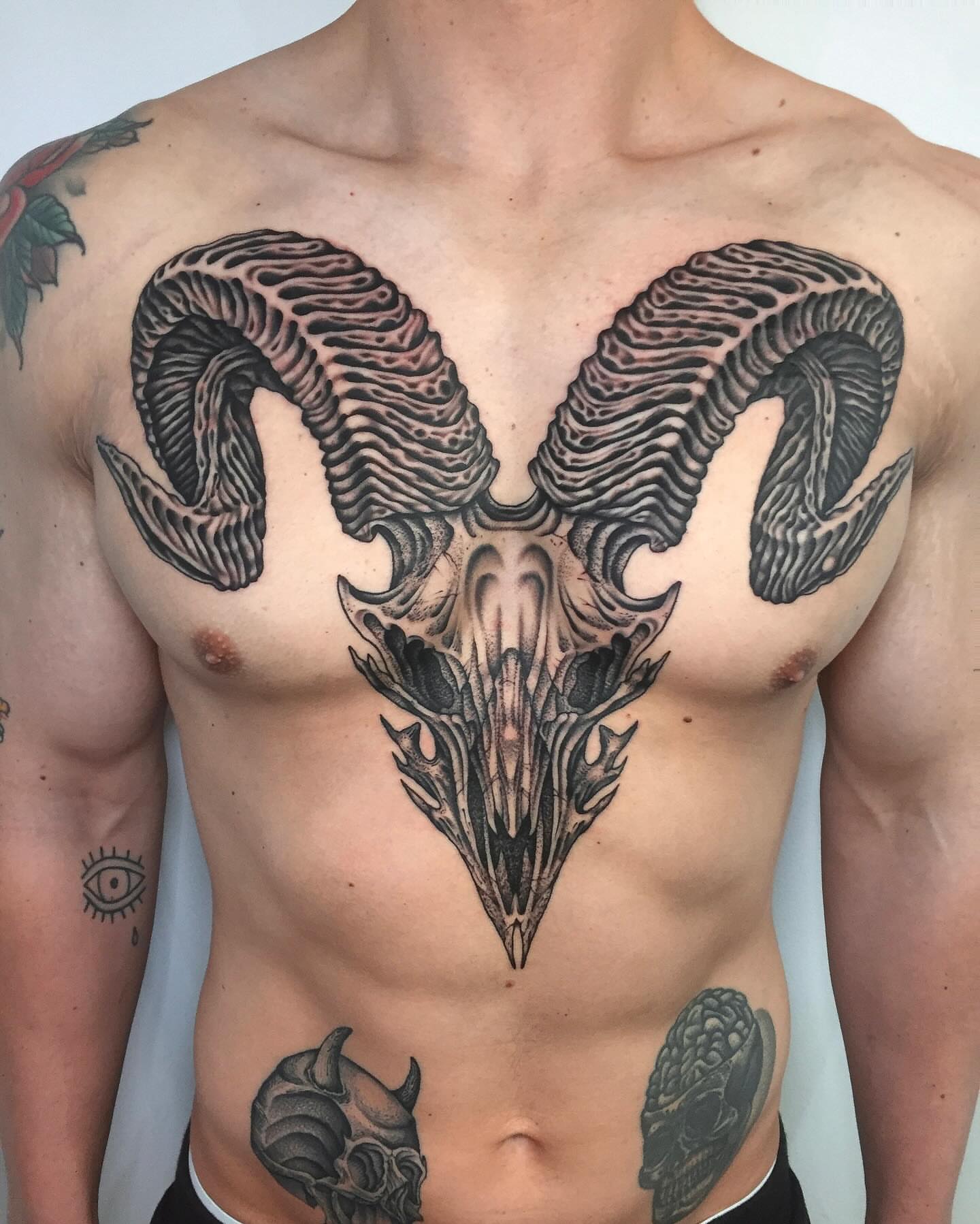 Ram skull black and grey tattoo on the chest by Monkey Bob Tattoo