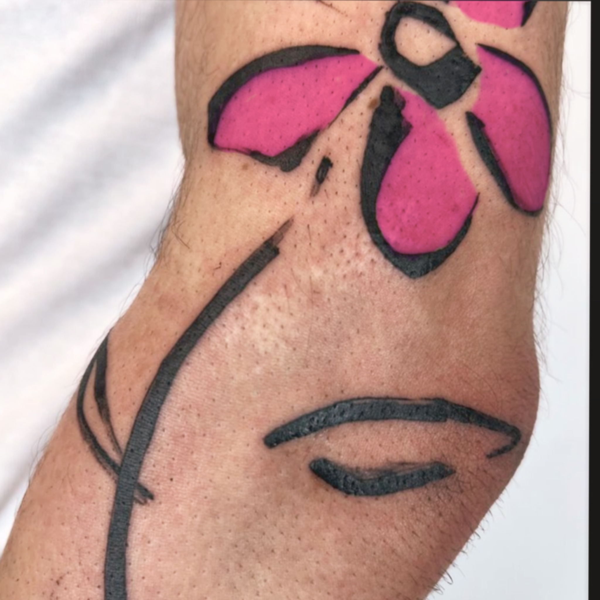 Abstract face tattoo on the forearm by Bennie Bae