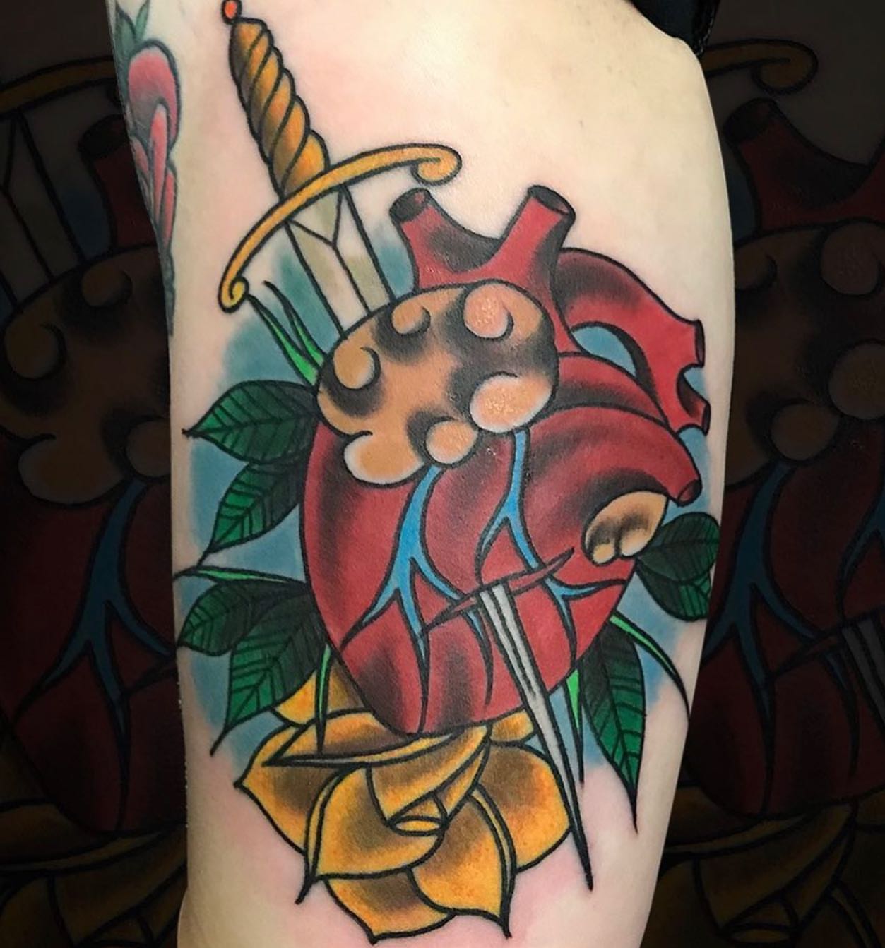 Heart with sword American traditional tattoo on the forearm by Nick Harrison, Dayton, Ohio