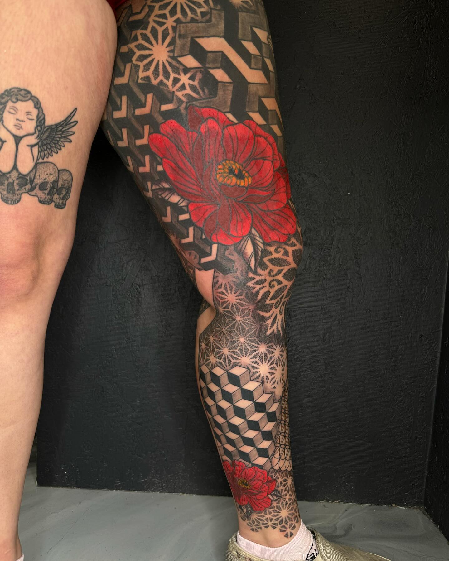 Red poppy geometric tattoo on the calf by @inkedbybanti