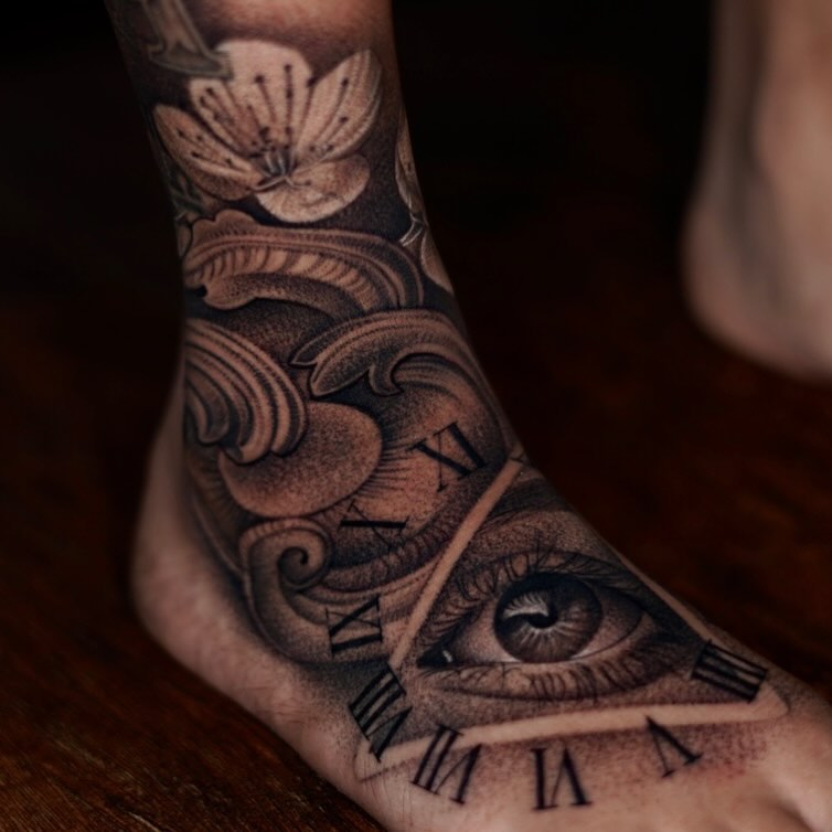Eye and Roman numerals geometric tattoo on the foot by DREW ROMERO - Colorado Tattoo Artist, Pueblo, Colorado