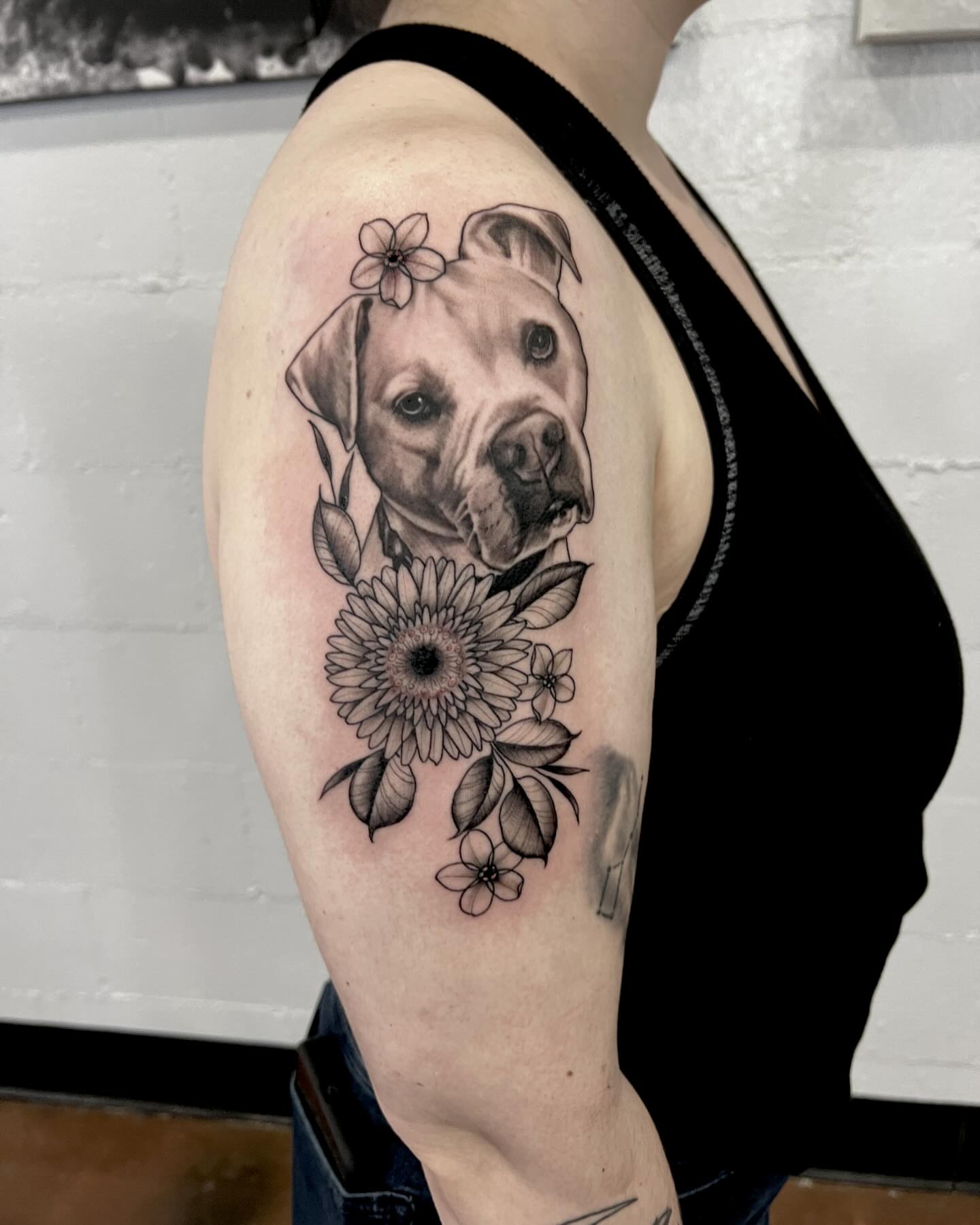 Dog with flowers realism tattoo on the shoulder by Drew Foster, Toledo, Ohio