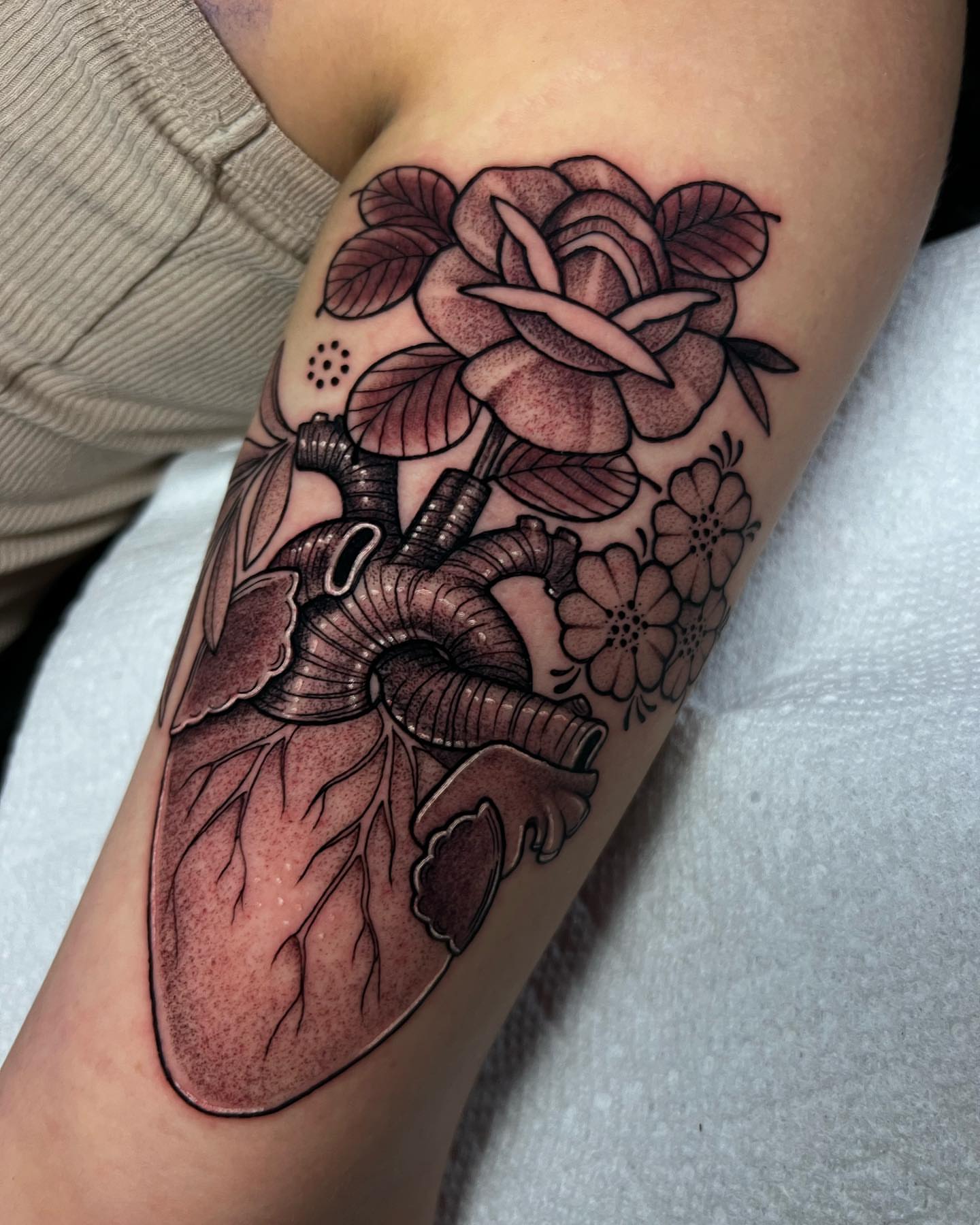 Anatomical heart with flowers realism tattoo on the forearm by ๐ฎ๐๐๐๐๐๐