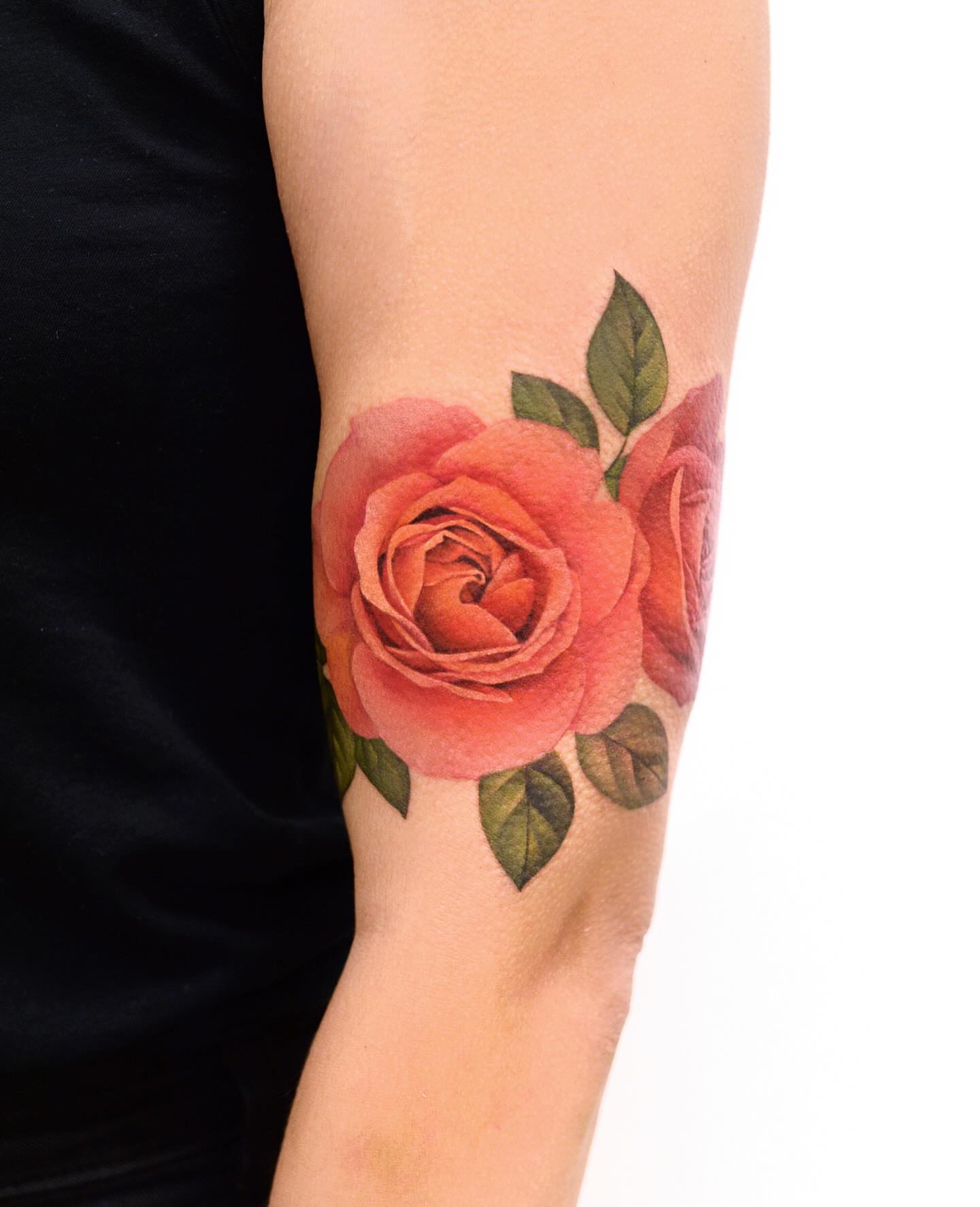 Rose realism tattoo on the forearm by Joice Wang