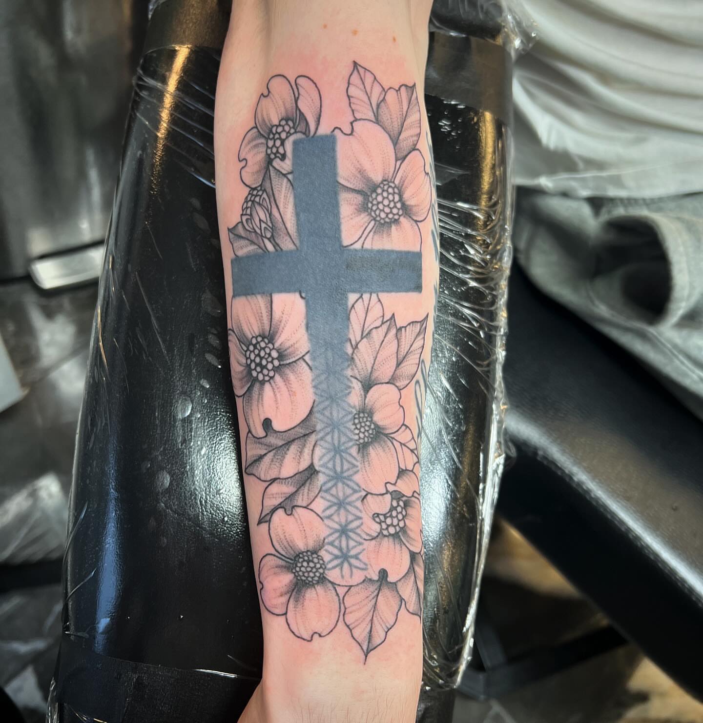 Cross with flowers dotwork tattoo on the forearm by Brooke, Kansas City, Missouri
