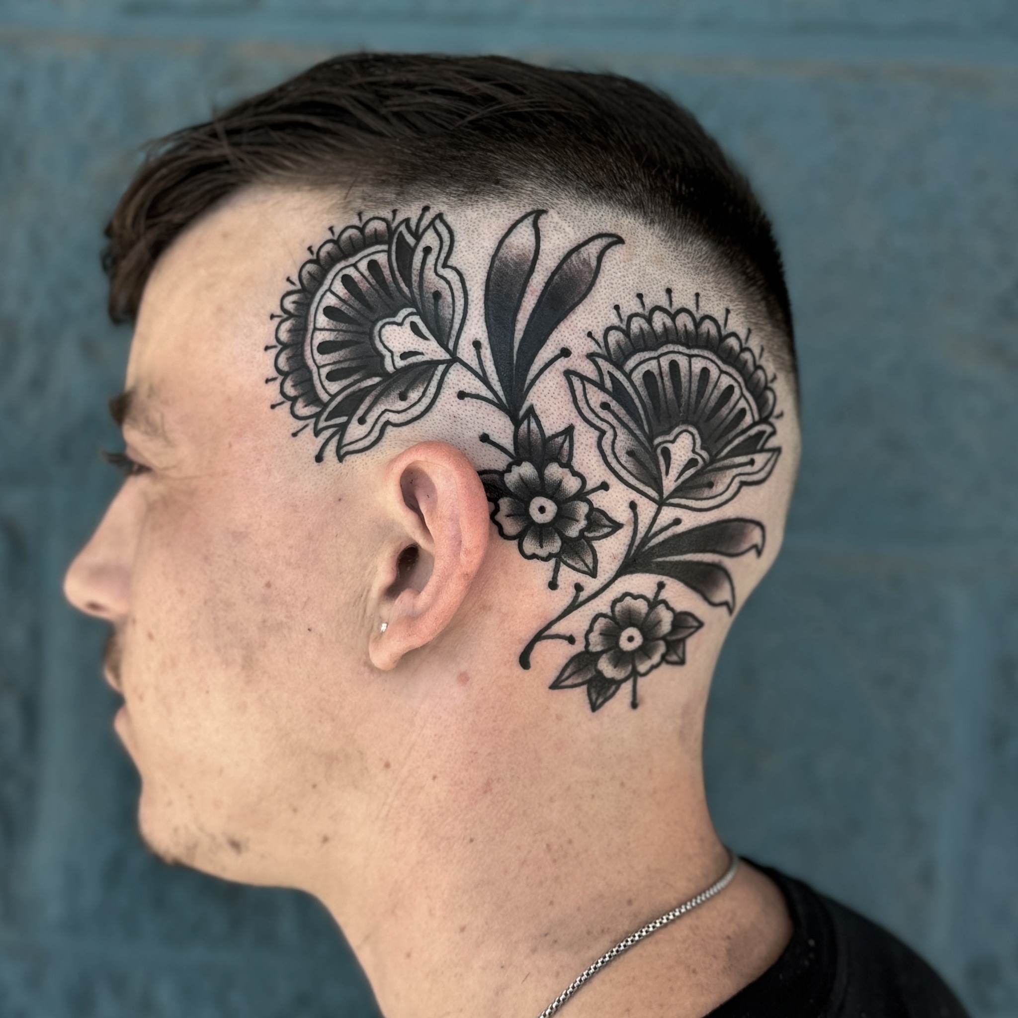Floral design black and grey tattoo on the head by Donovan hernandez