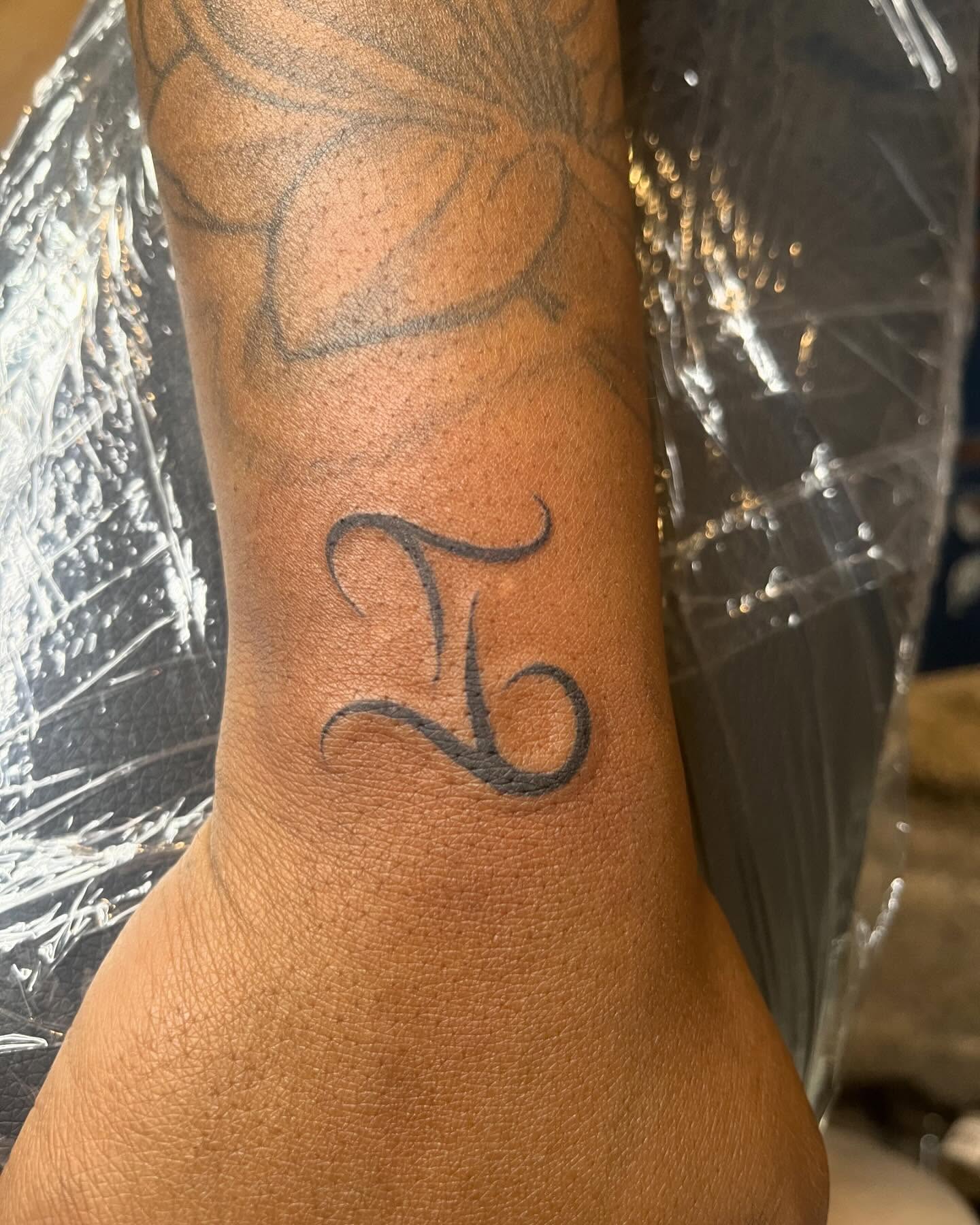 Zodiac symbol black and grey tattoo on the forearm by Bris