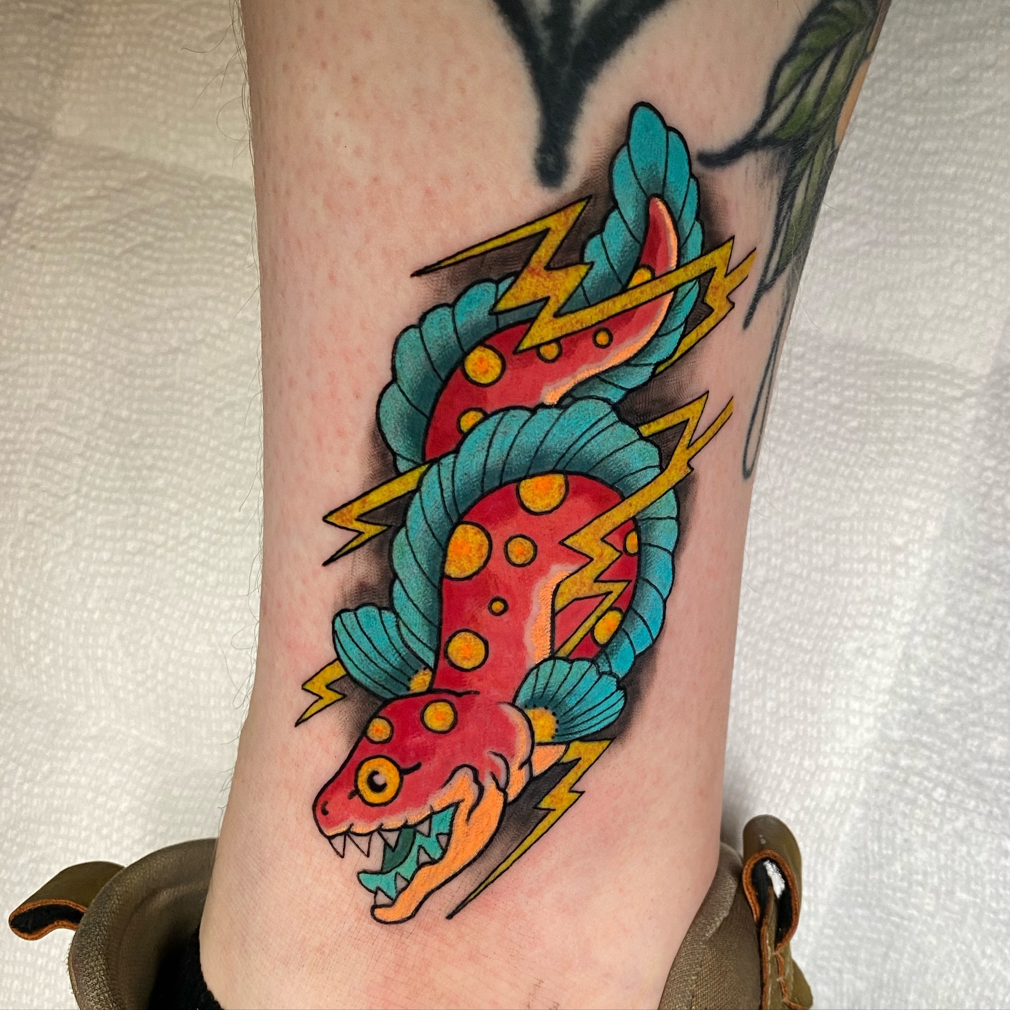 Snake American traditional tattoo on the forearm by Mitch Bonifay
