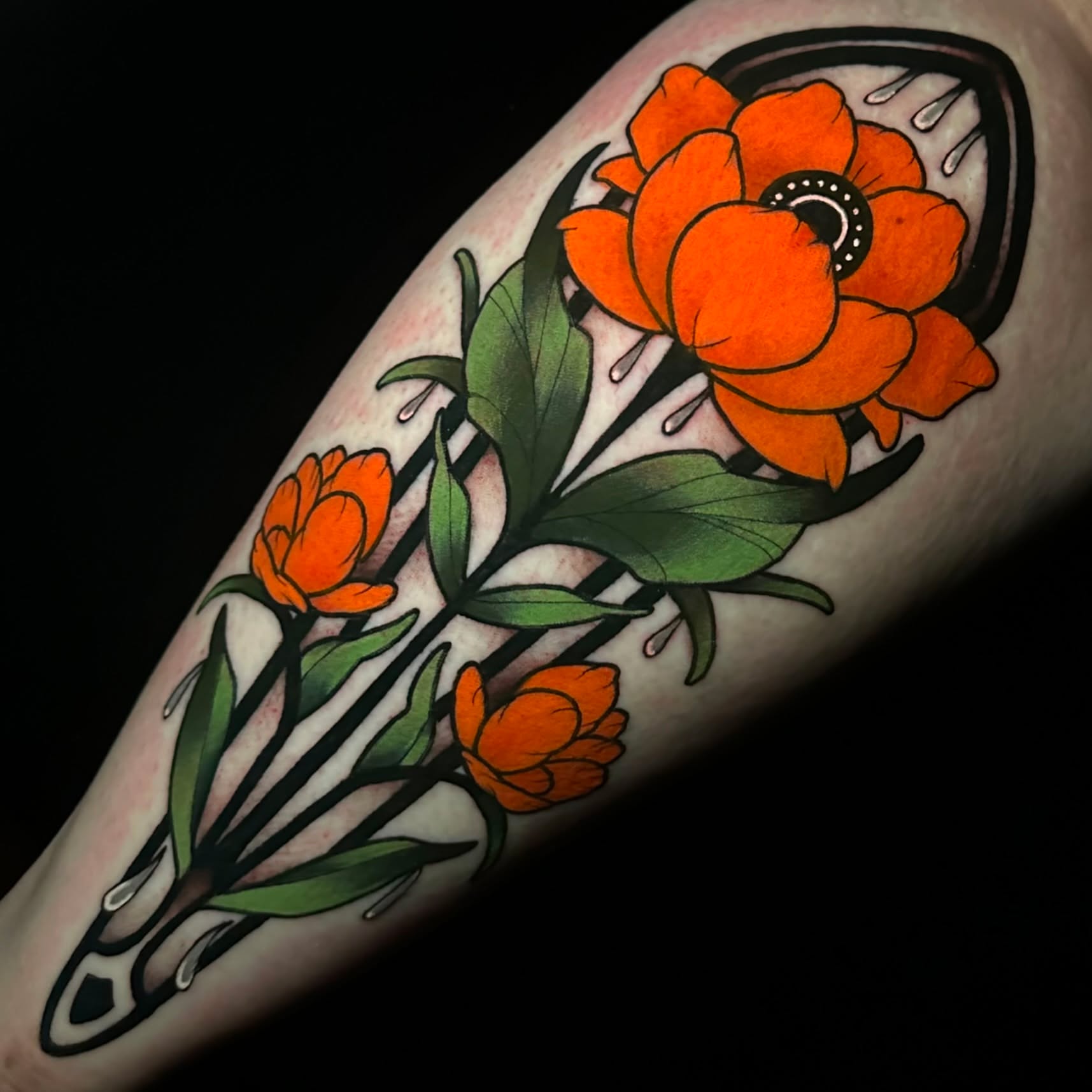 Orange flowers American traditional tattoo on the forearm by gillian marie