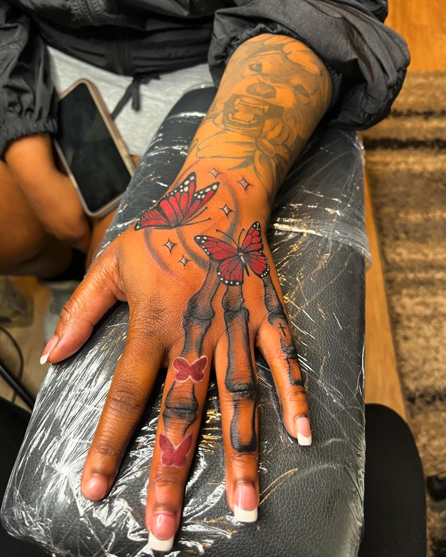 Butterflies and tiger stripes American traditional tattoo on the hand by Bris