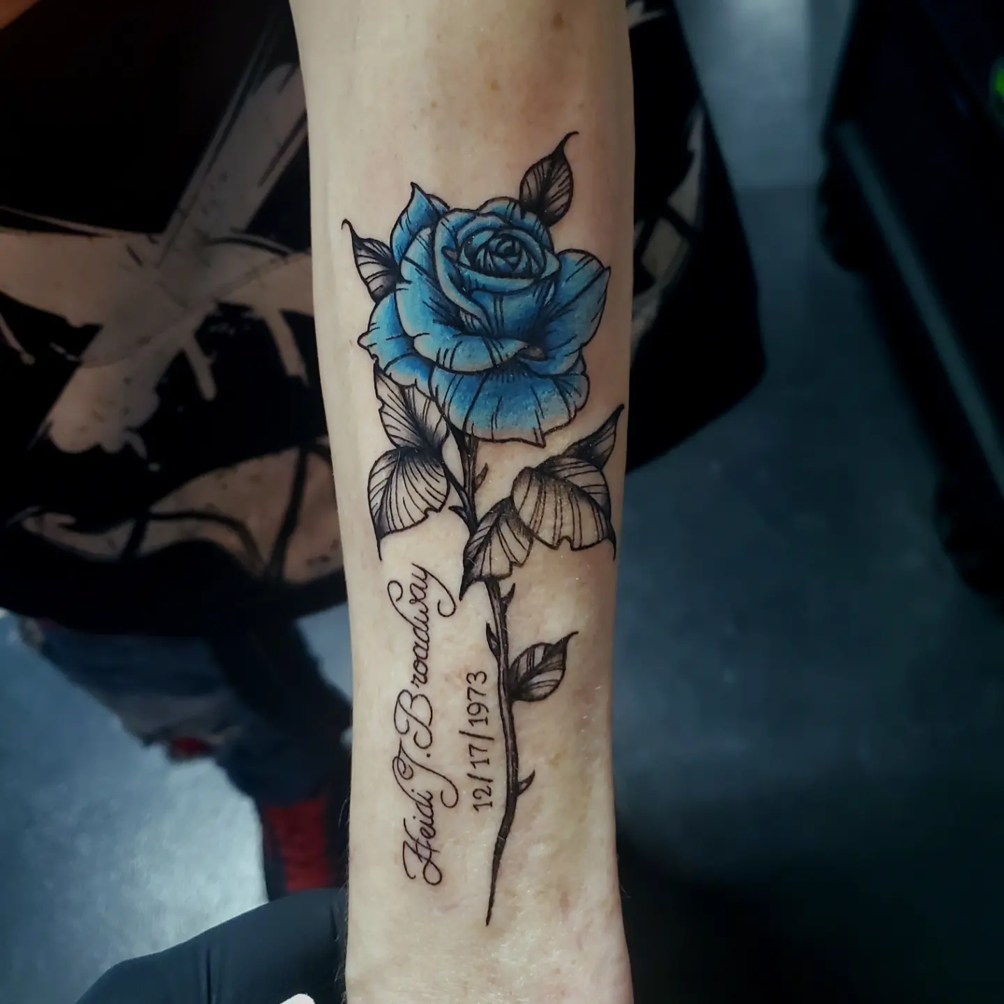 Blue rose black and grey tattoo on the forearm by Shailey Pasquale