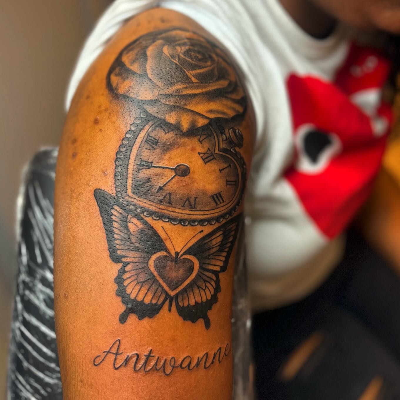 Clock, rose, butterfly, heart realism tattoo on the forearm by Bris