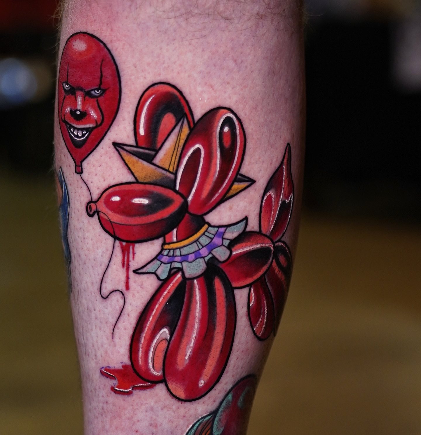 Red clown balloon American traditional tattoo on the forearm by B.G. Germershausen
