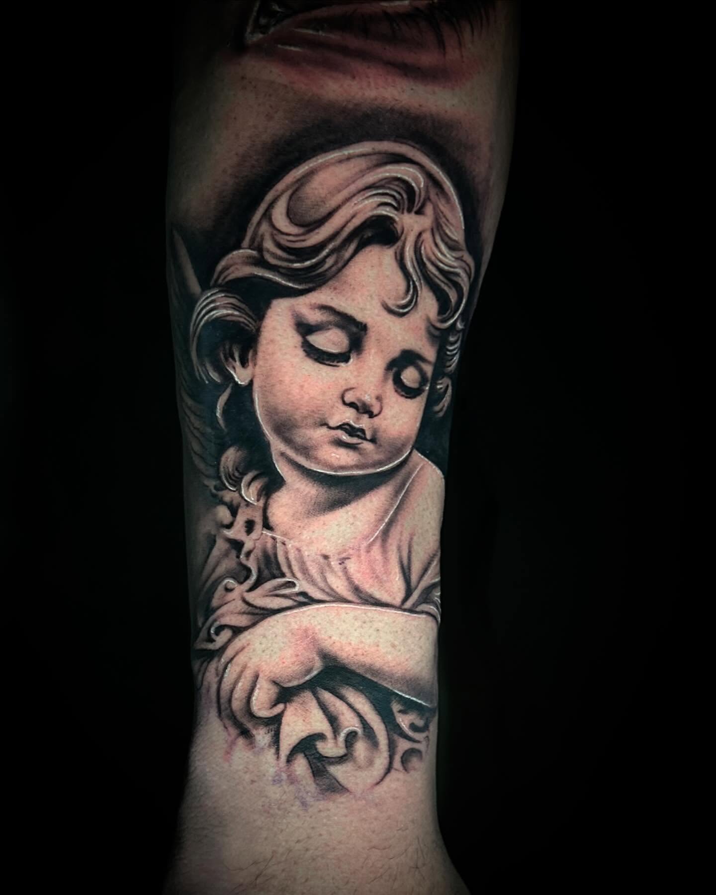 Cherub realism tattoo on the forearm by Tattoo Artist - the Goat