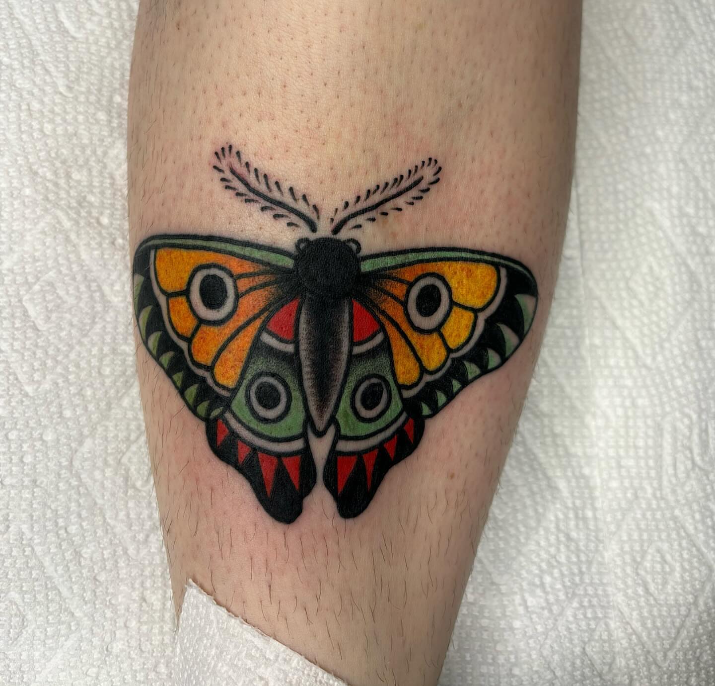 Butterfly American traditional tattoo on the forearm by Emmy Gallagher