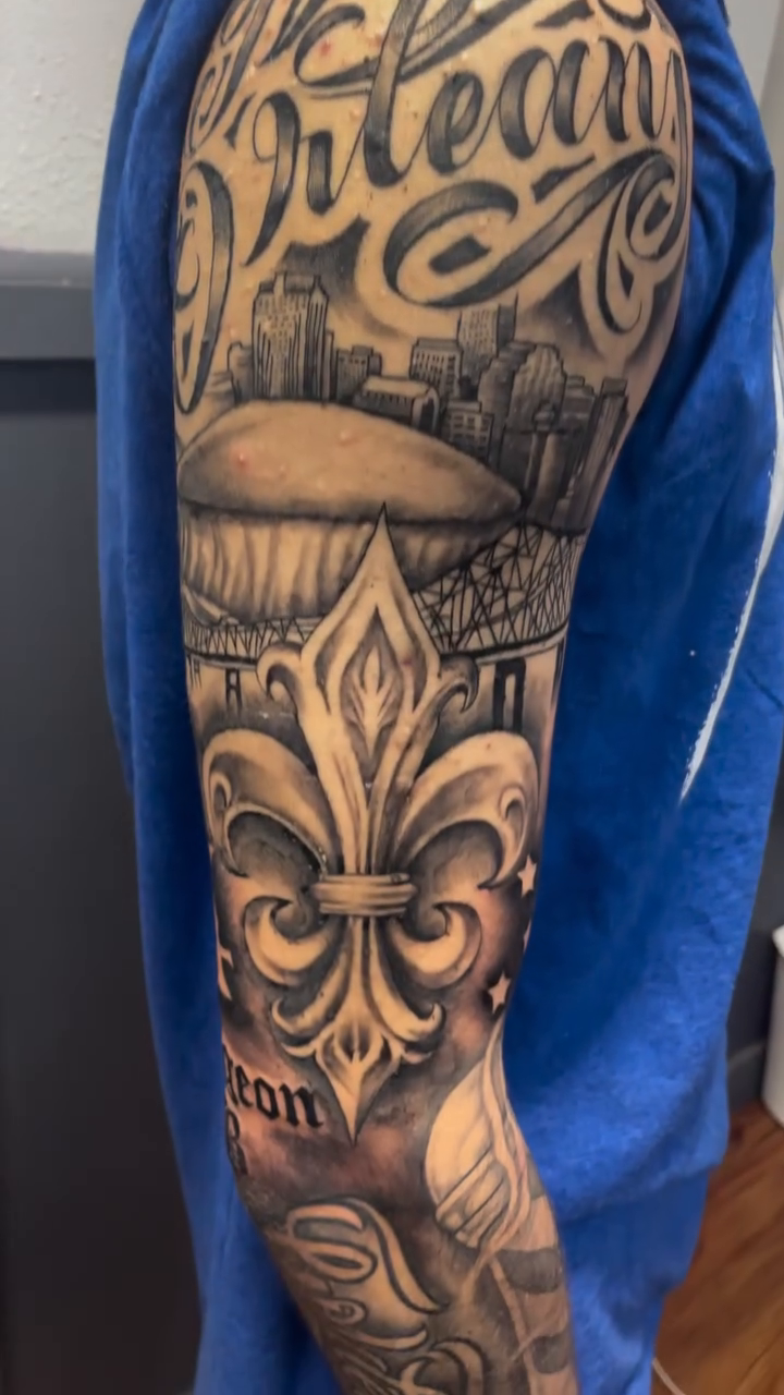 New Orleans themed sleeve with script lettering script tattoo by Blake