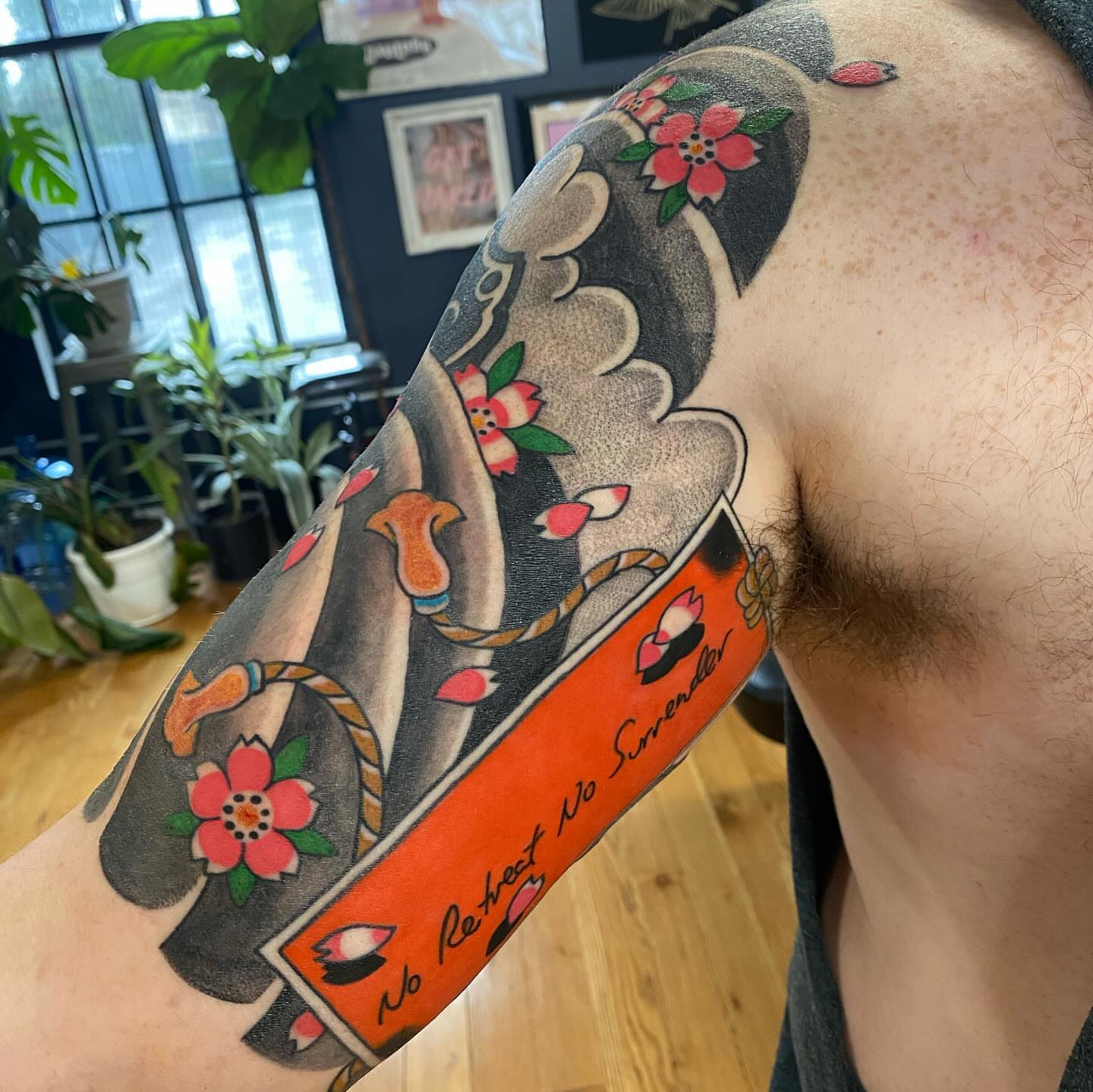Card with floral design American traditional tattoo on the upper arm by S C O T T