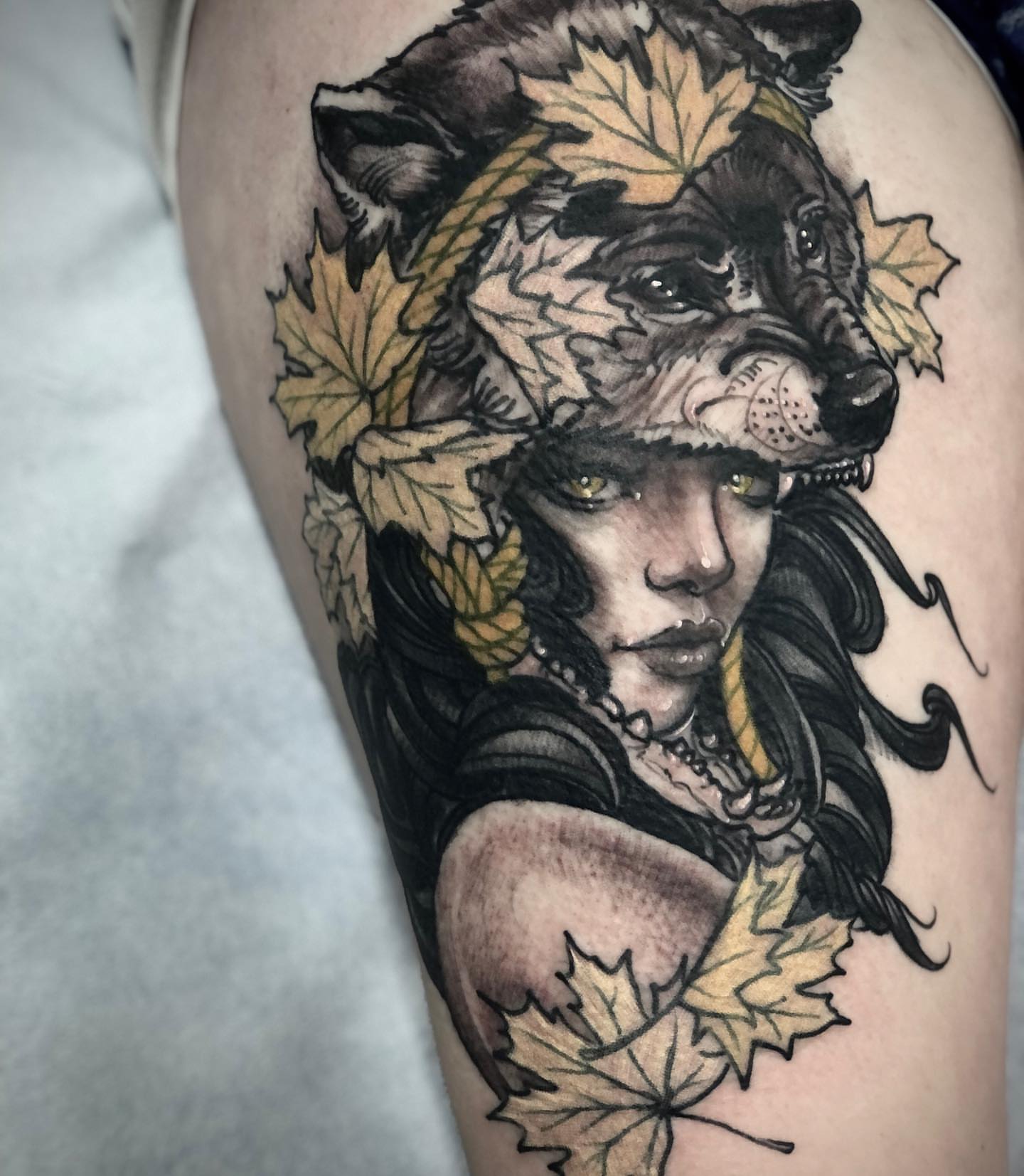 Woman with wolf realism tattoo on the thigh by Alec Bauer
