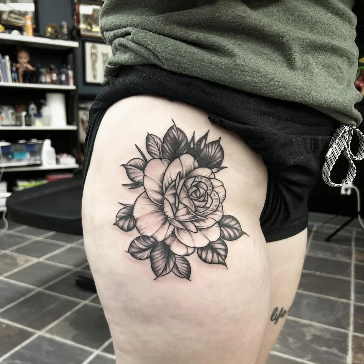 Rose black and grey tattoo on the thigh by Dylan Stevens