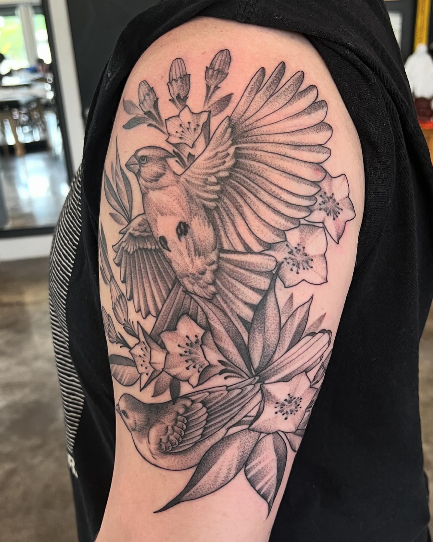 Bird and flowers dotwork tattoo on the shoulder by Will Campbell
