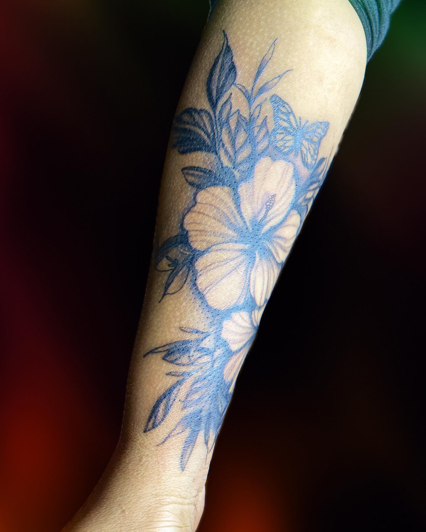 Floral arrangement black and grey tattoo on the forearm by Tiffany
