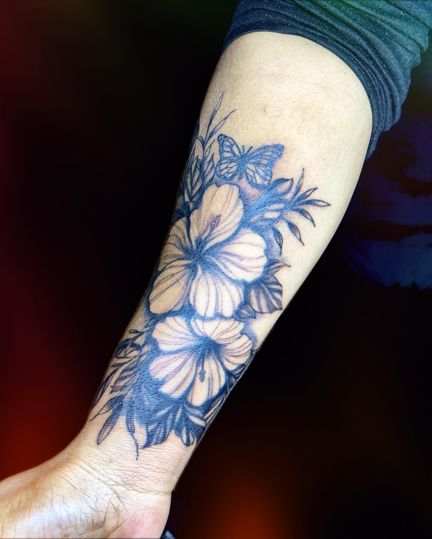 Hibiscus flowers black and grey tattoo on the forearm by Tiffany