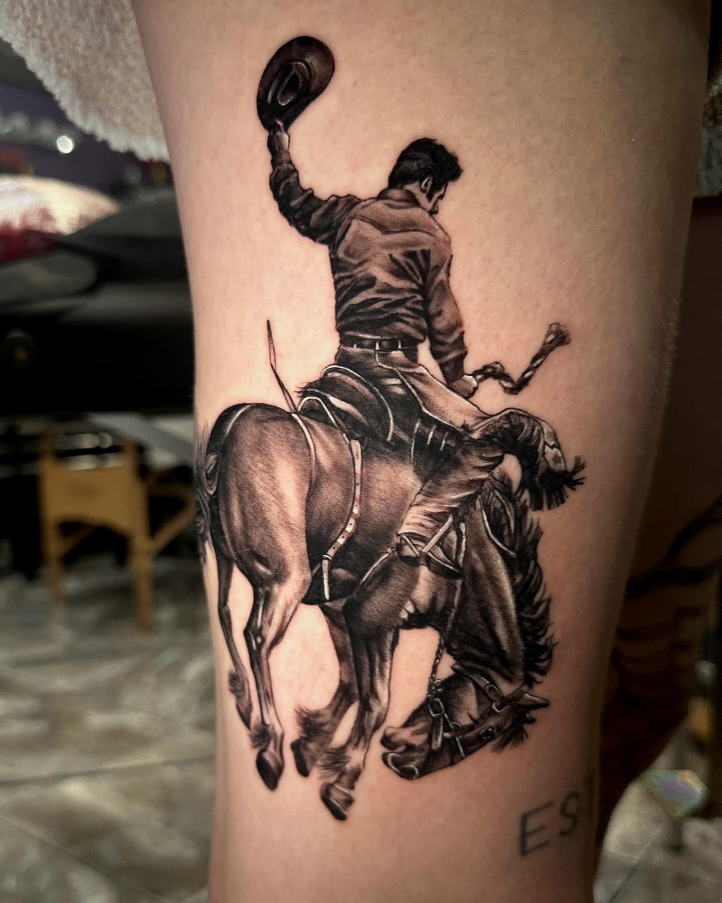 Cowboy riding horse realism tattoo on the thigh by Billy Harris