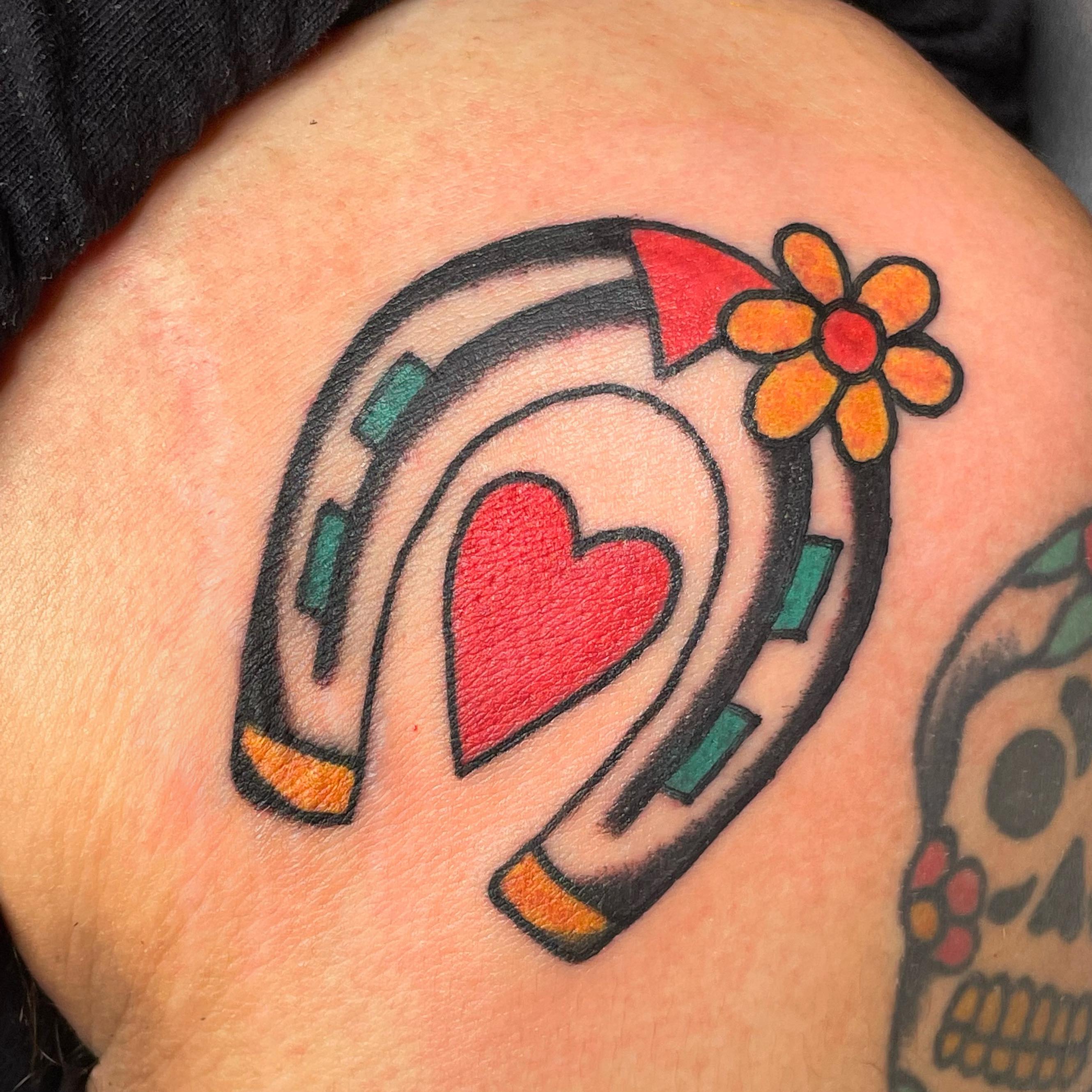 Horseshoe with heart American traditional tattoo on the shoulder by nancy❣️