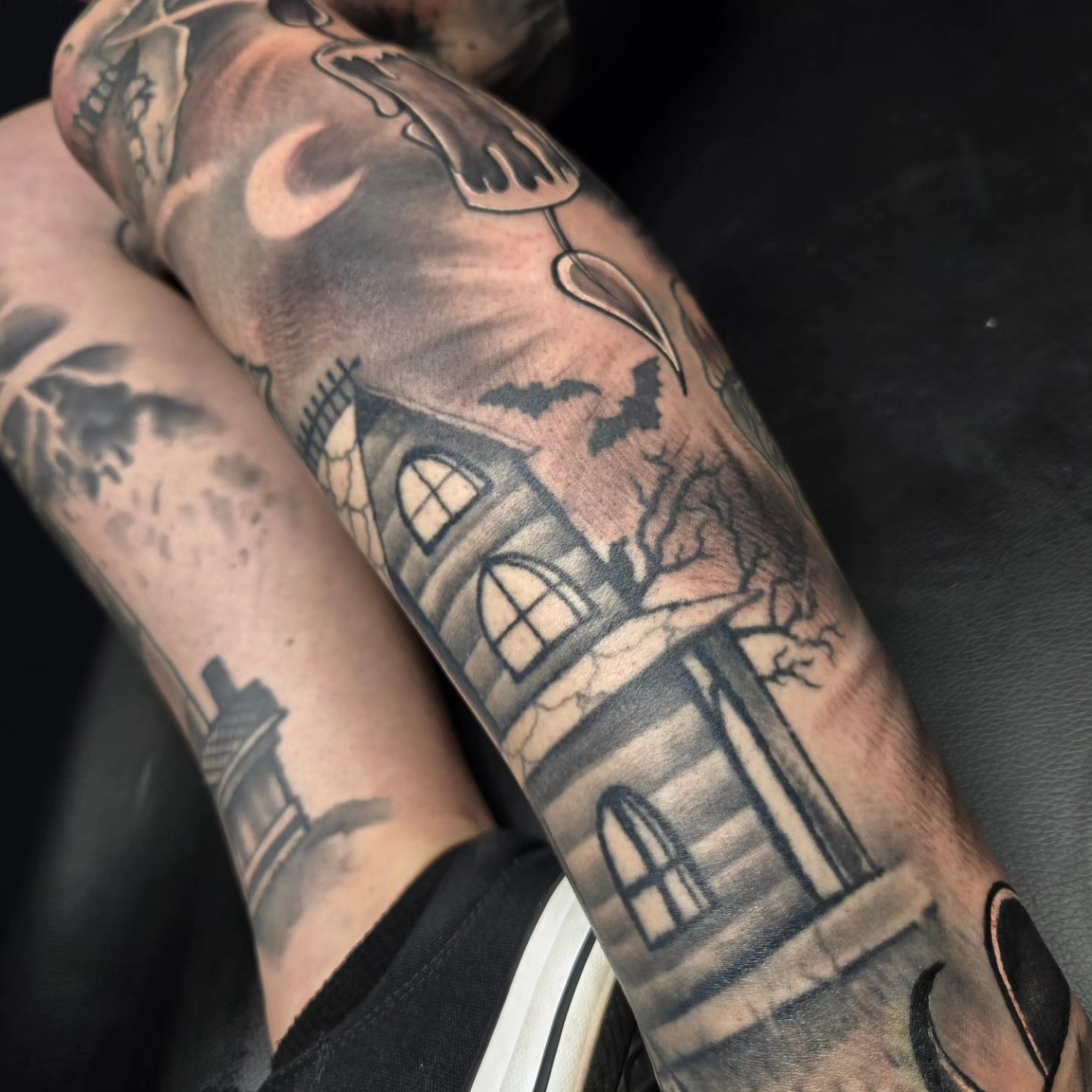 Haunted house realism tattoo on the forearm by David Johnson