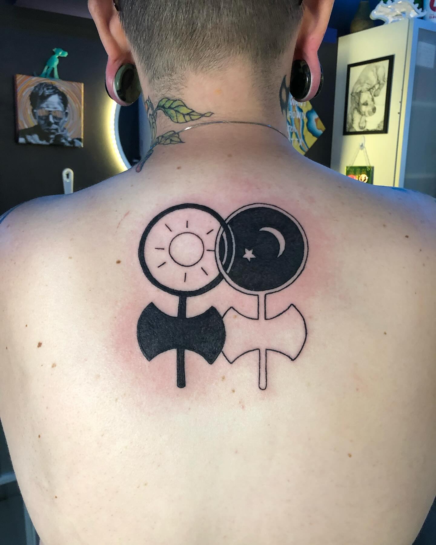 Sun and moon geometric tattoo on the back by Tesla Kohl
