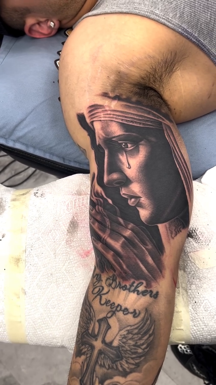 Religious figure with praying hands realism tattoo by Andrew Wine🍷Tattoo