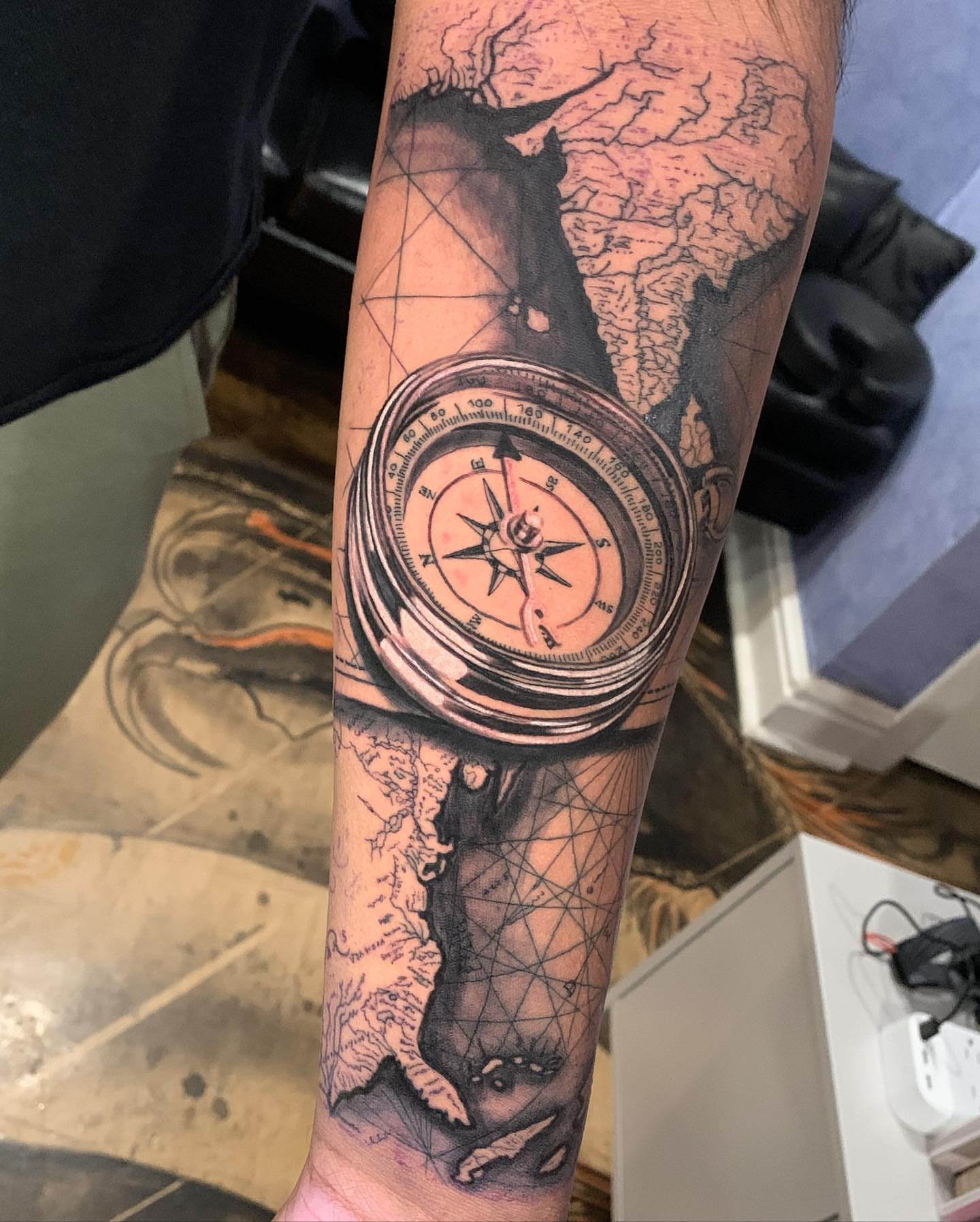 Compass and map realism tattoo on the forearm by james padelt