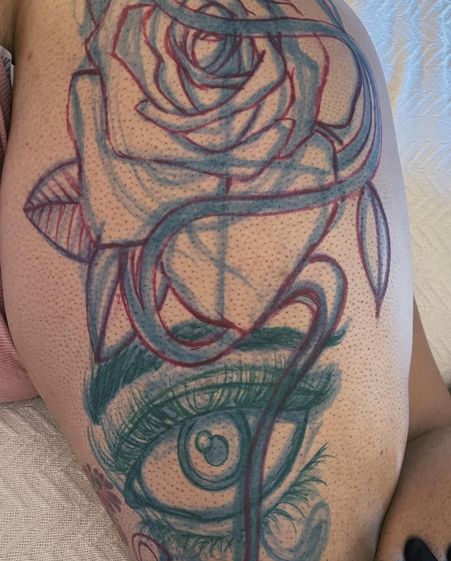 Rose and eye dotwork tattoo on the thigh by Azaan (Zanye), Birmingham, Alabama